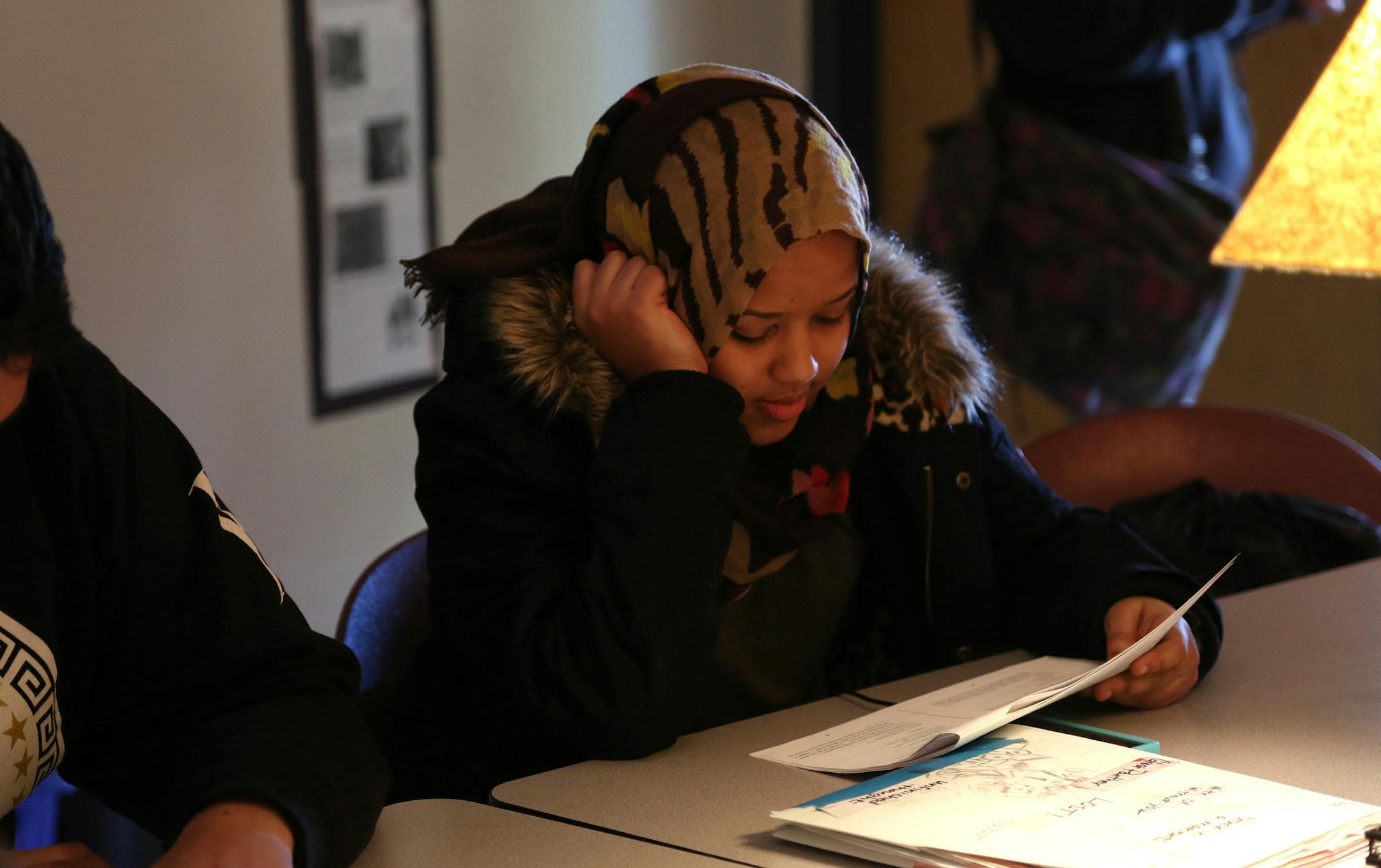 Murnira Ahmed listened as she waited for her turn to read aloud in English class. ] (KYNDELL HARKNESS/STAR TRIBUNE) kyndell.harkness@startribune.com Crossroads West High School in Champlin Min., Thursday, March 5, 2015.