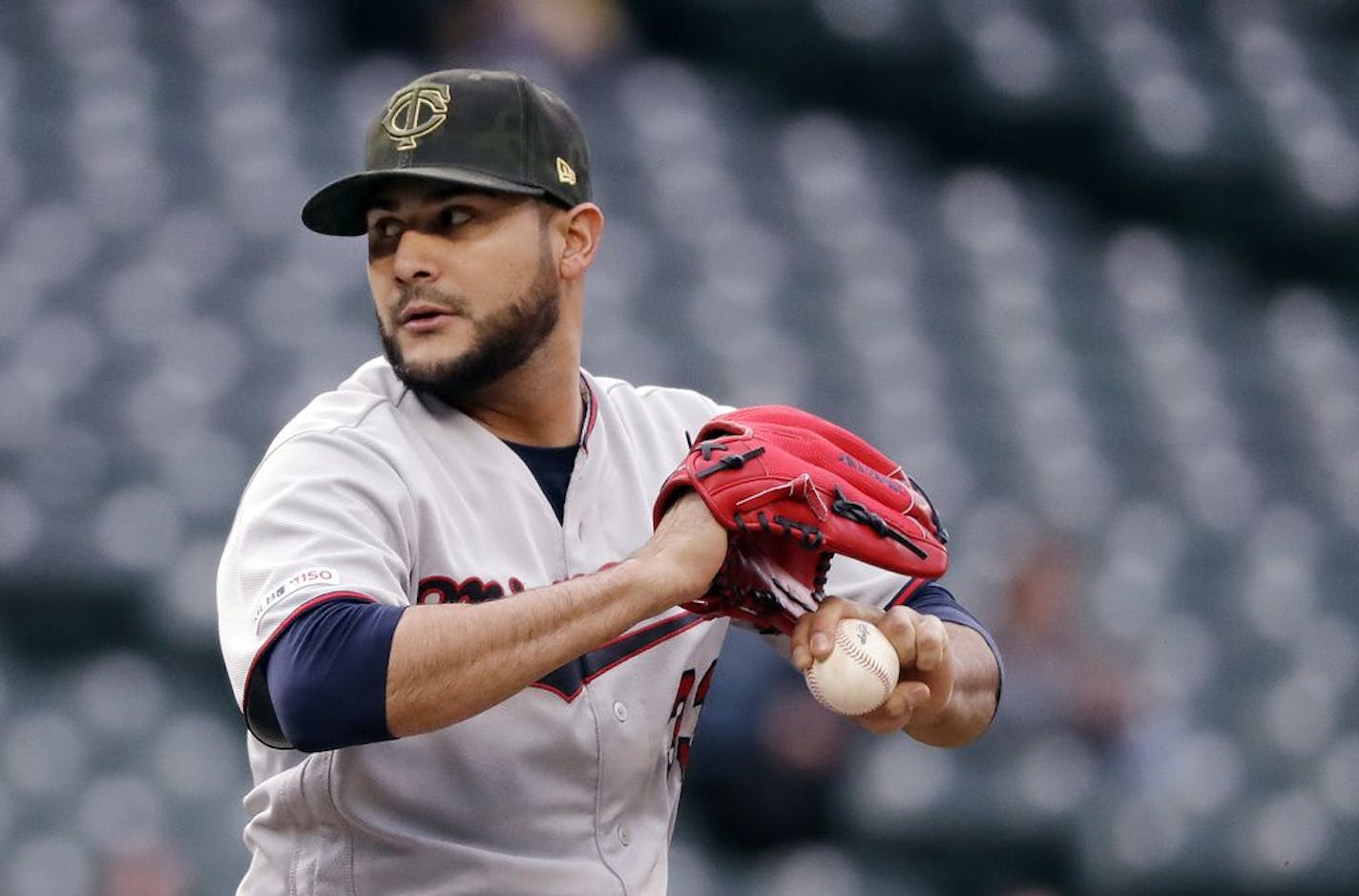 Minnesota Twins starting pitcher Martin Perez winds up during the first inning of the team's baseball game against the Seattle Mariners on Friday, May 17, 2019, in Seattle.