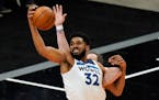 Minnesota Timberwolves center Karl-Anthony Towns (32) reaches for a pass during the second half of an NBA basketball game against the Utah Jazz Saturd