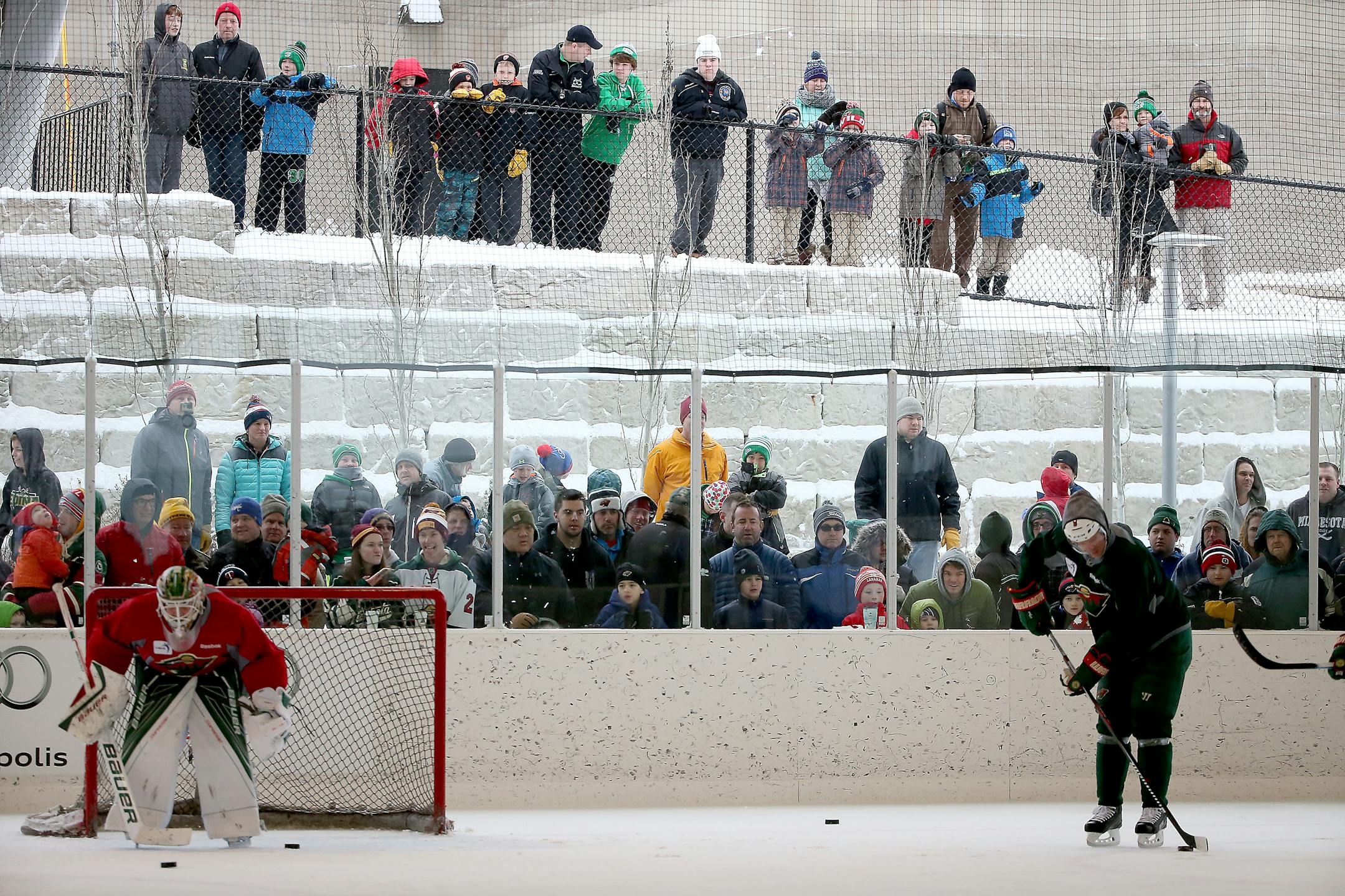 Fans watch as the Minnesota Wild practice at the Backyard outdoor ice rink at Braemar Arena, Tuesday, Dec. 29, 2015 in Edina.