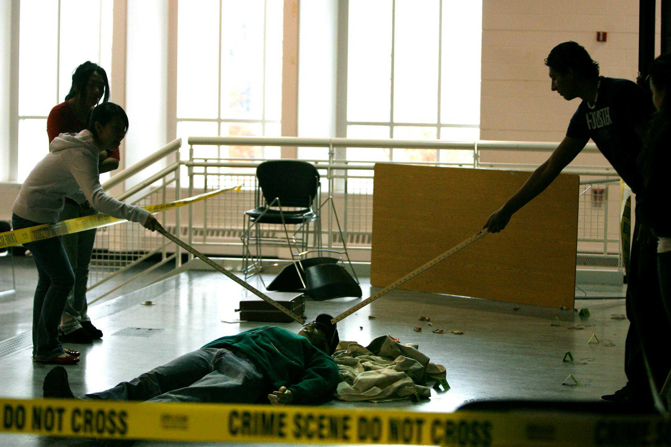 An Arlington High School physics class examined a makeshift crime scene during their class to determine blood spatter patterns and whether the body was moved to the scene or killed there. Arlington High School is spending three weeks staging a murder scene investigation and trial from start to finish.