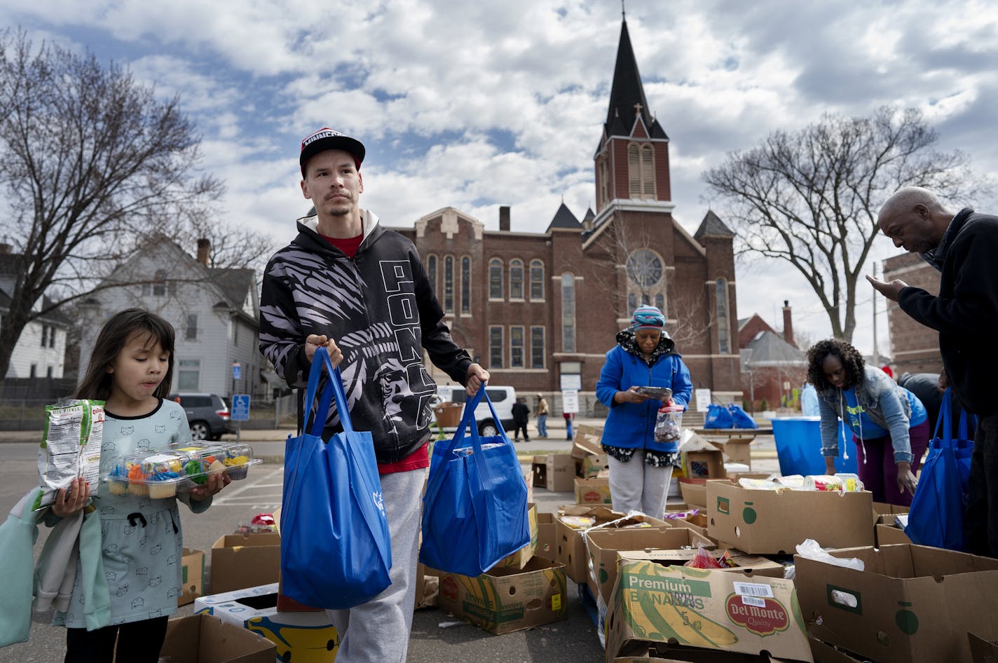 Anthony Steeprock and his daughter carried food from the parking lot of Greater Mount Vernon Missionary Baptist Church . Five thousands pounds of food was donated through Second Harvest Heartland to help with families dealing with COVID-19 .] Jerry Holt &#x2022;Jerry.Holt@startribune.com A food give away was held In the parking lot of the Greater Mount Vernon Missionary Baptist Church Thursday April 2, 2020 in north Minneapolis, MN.