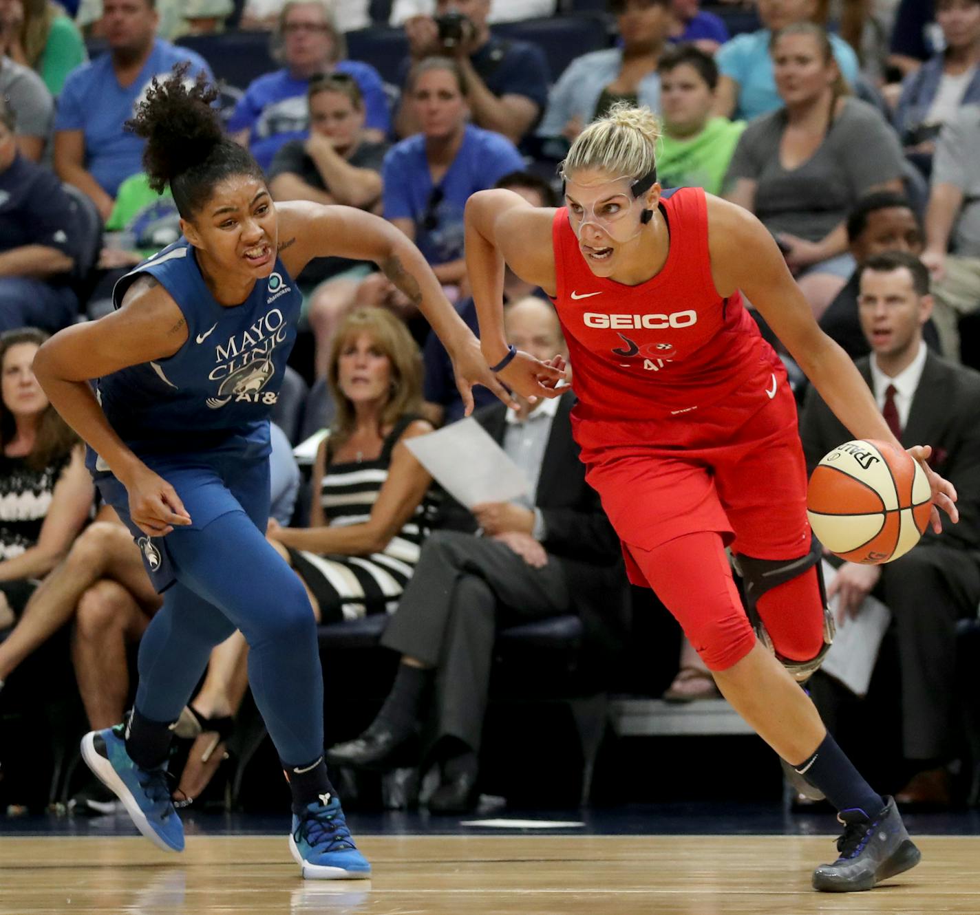 The Minnesota Lynx's Damiris Dantas (92) loses a step on a driving Elena Delle Donne (11) of the Washington Mystics last season.