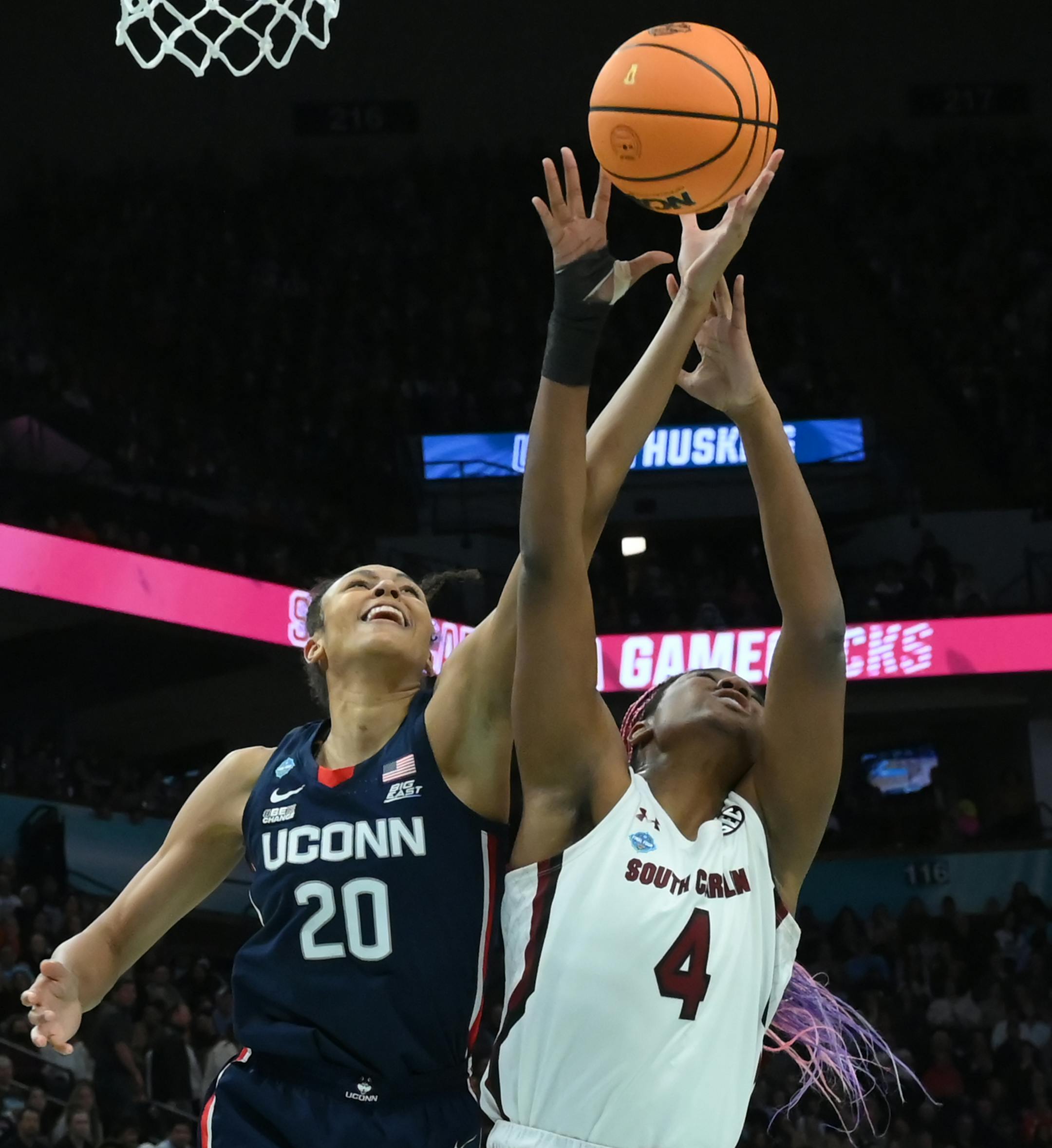 UConn forward Olivia Nelson-Ododa (20) and South Carolina forward Aliyah Boston (4) reach for a rebound during the second quarter.
