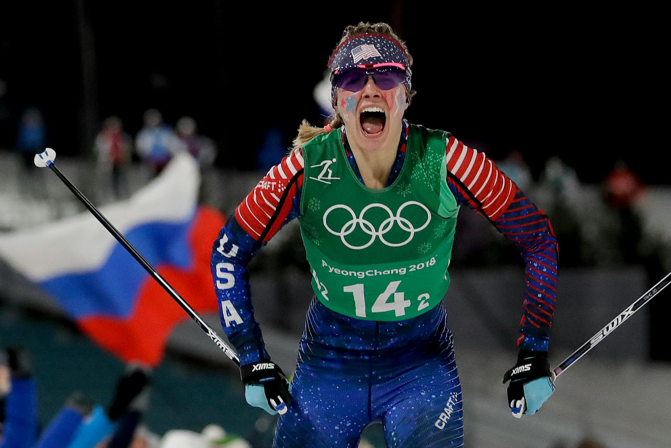 Jessie Diggins, of the United States, celebrates after winning the gold medal in the during women's team sprint freestyle cross-country skiing final at the 2018 Winter Olympics.