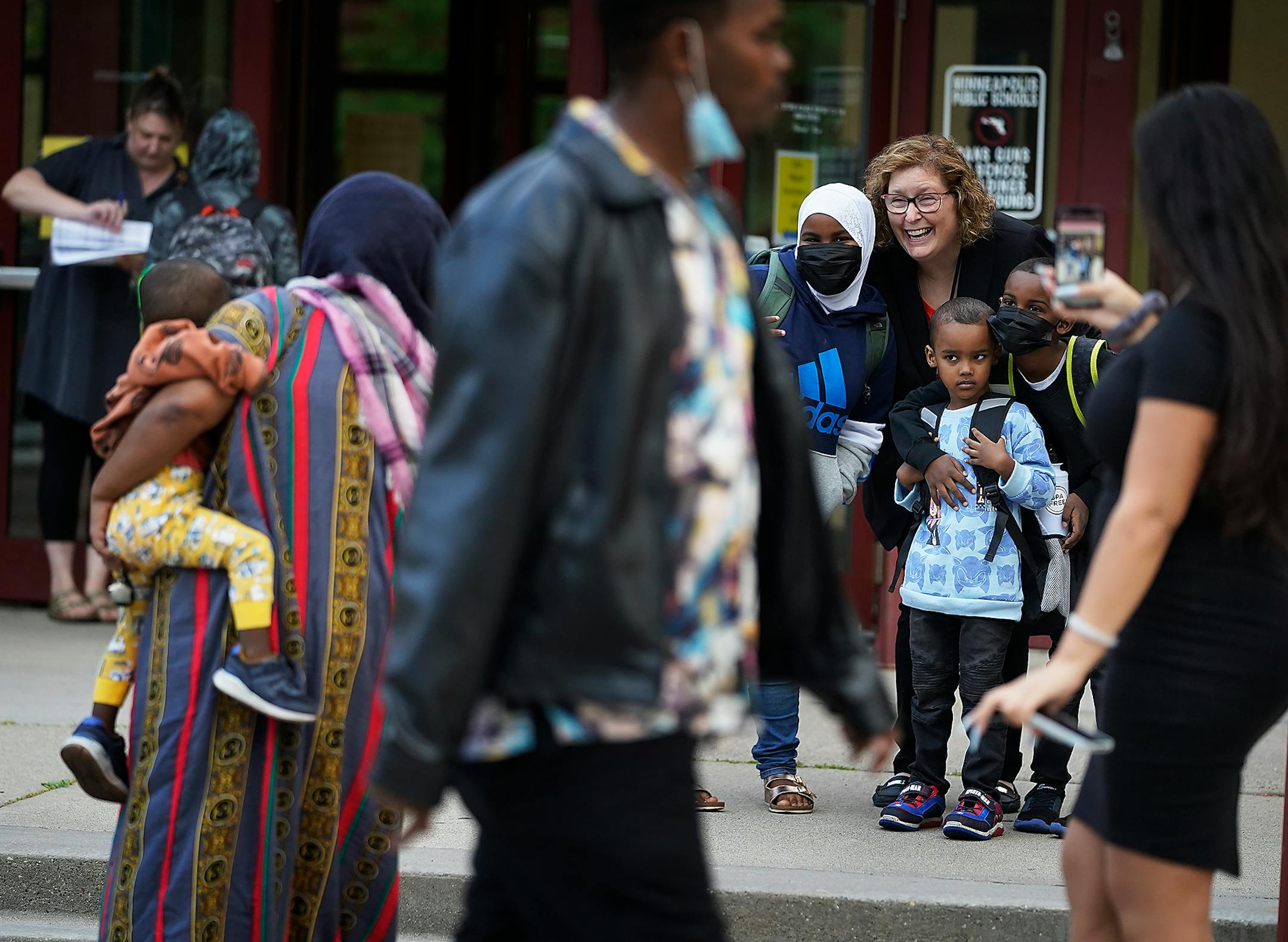 Interim Minneapolis Public Schools Superintendent Rochelle Cox posed with students for a photo outside Anishinabe Academy and Sullivan STEAM School, both housed in the same building, as Cox toured the schools on the first day of school in Minneapolis.