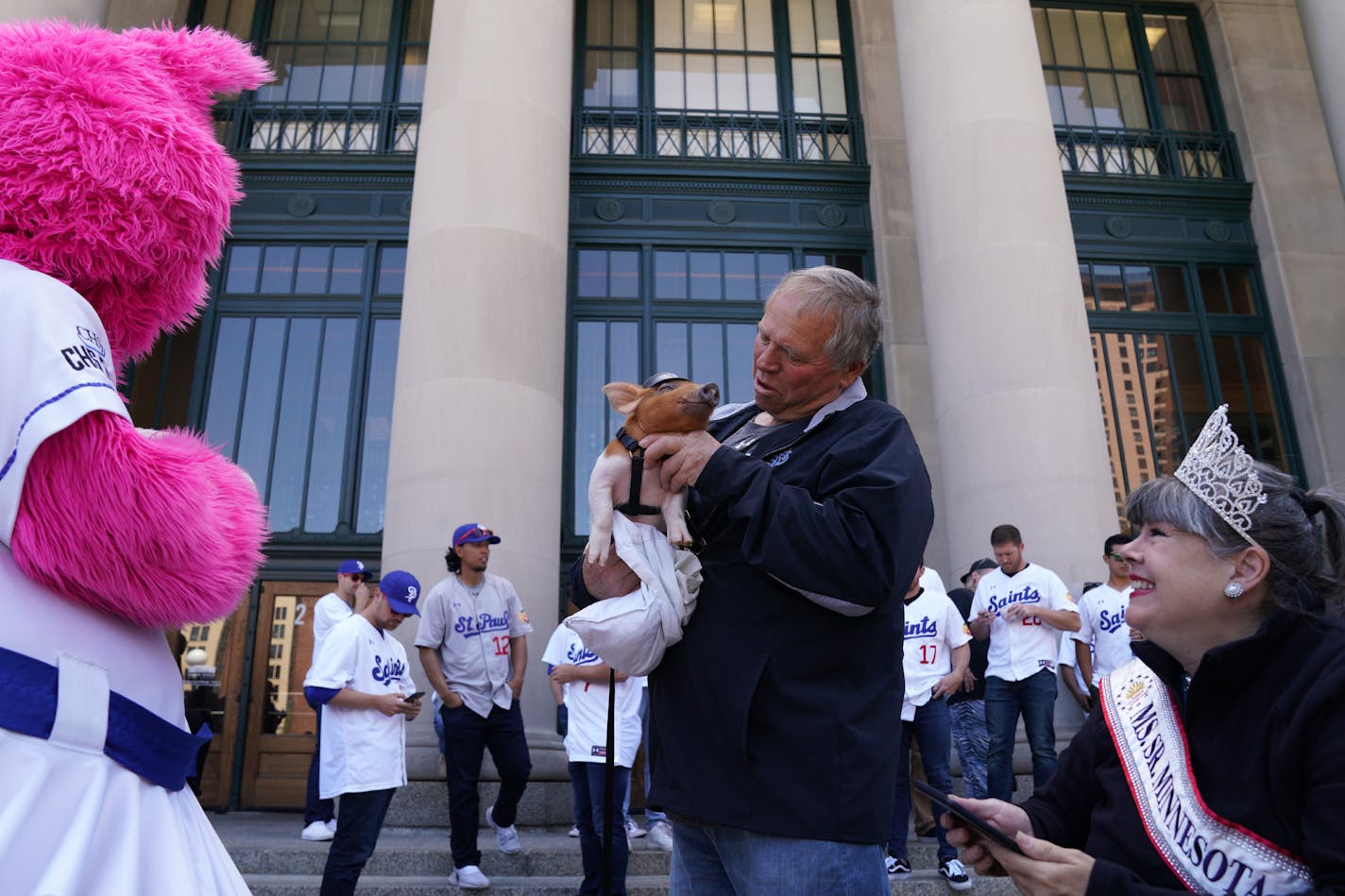 a man holds a baby pig