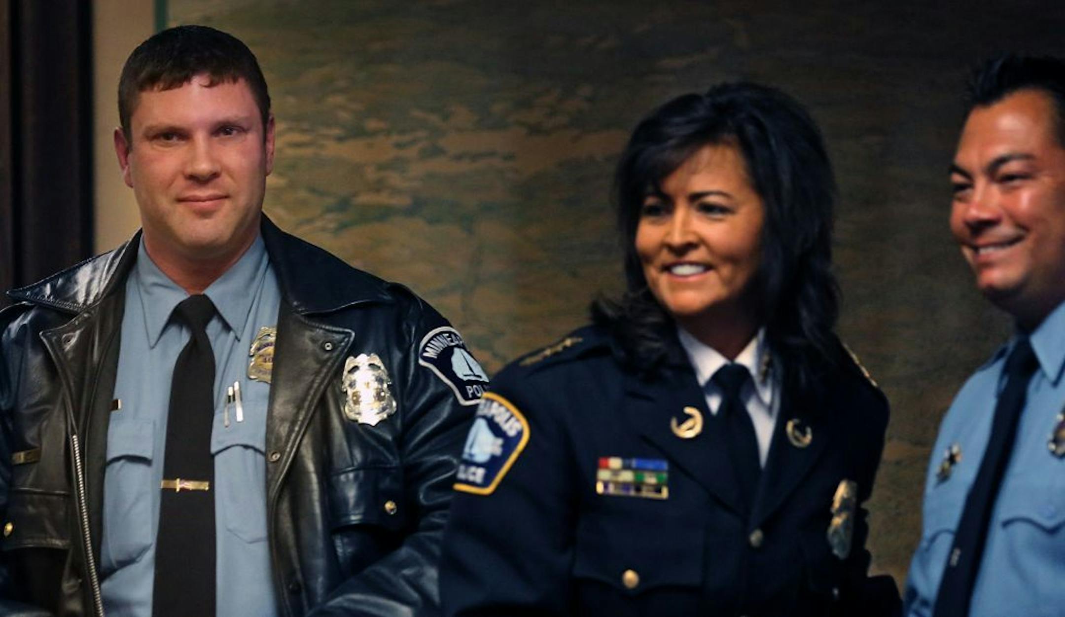 Minneapolis police officers Steven Lecy (left) and Sean McTaggert received the Excellence in Investigation award from Police Chief Janee Harteau during a ceremony at City Hall.