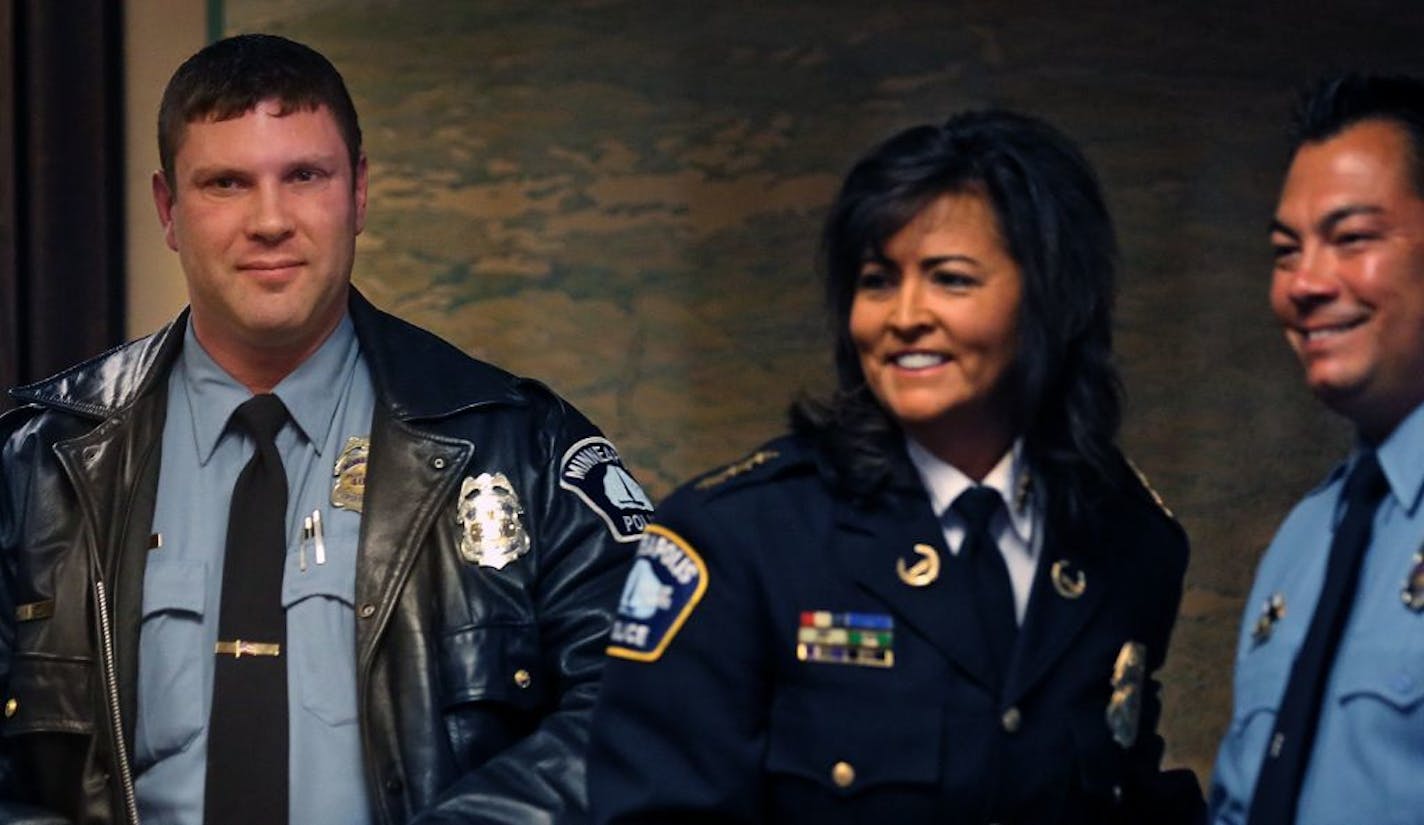 Minneapolis police officers Steven Lecy (left) and Sean McTaggert received the Excellence in Investigation award from Police Chief Janee Harteau during a ceremony at City Hall.