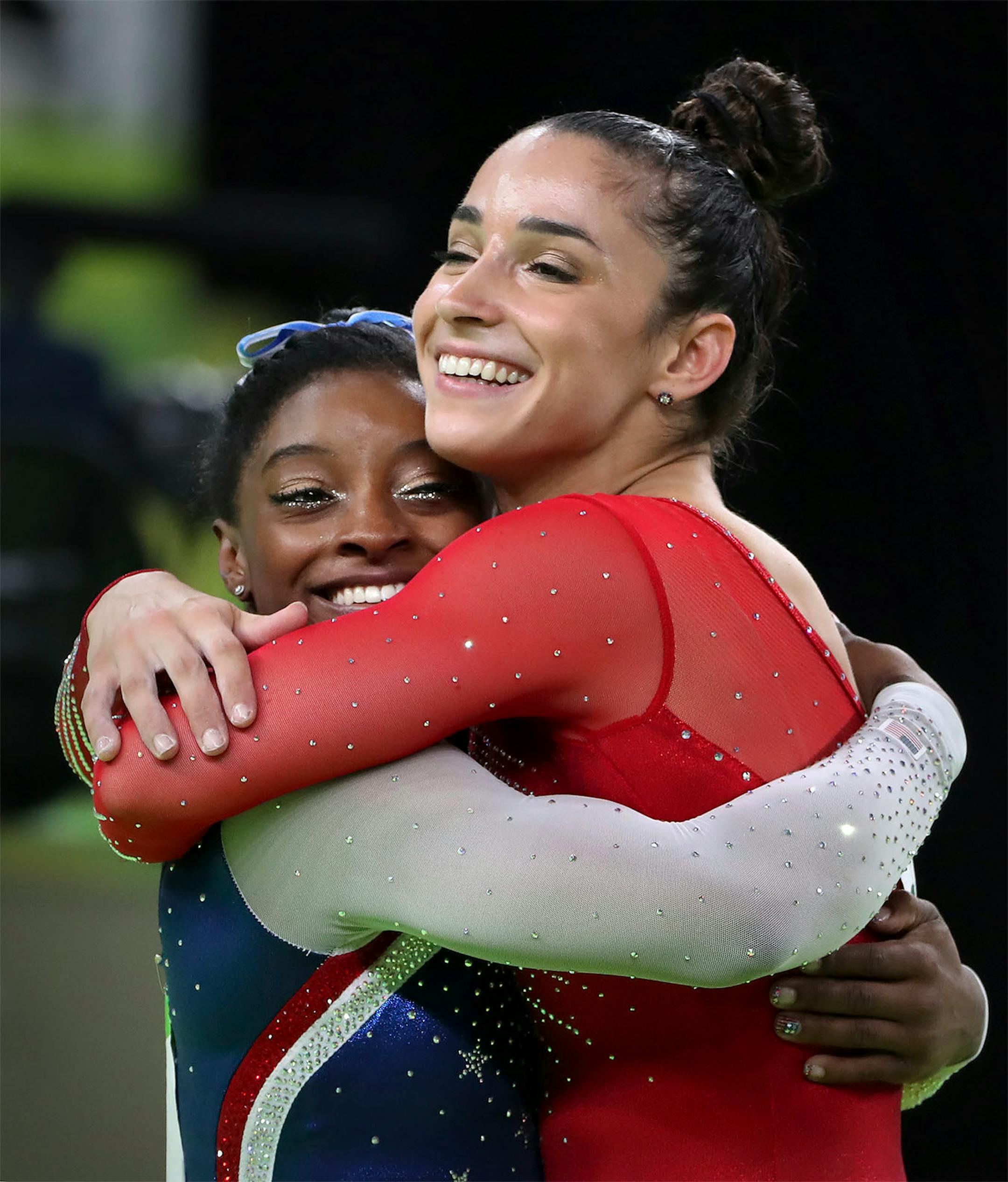 USA's Simone Biles won the all around title in women's gymnastics and her teammate Alexandra Raisman took home the silver. Here, they embrace after it was announced in the arena.