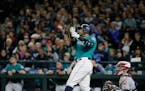 Seattle Mariners' Nelson Cruz watches his walk-off home run, which scored Robinson Cano, in the ninth inning of a baseball game against the Cleveland 