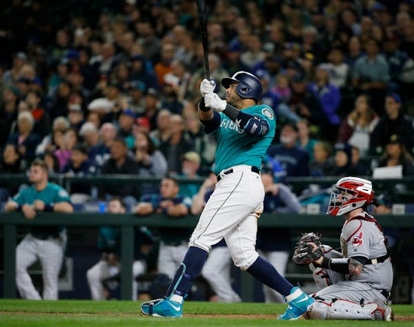 Seattle Mariners' Nelson Cruz watches his walk-off home run, which scored Robinson Cano, in the ninth inning of a baseball game against the Cleveland 