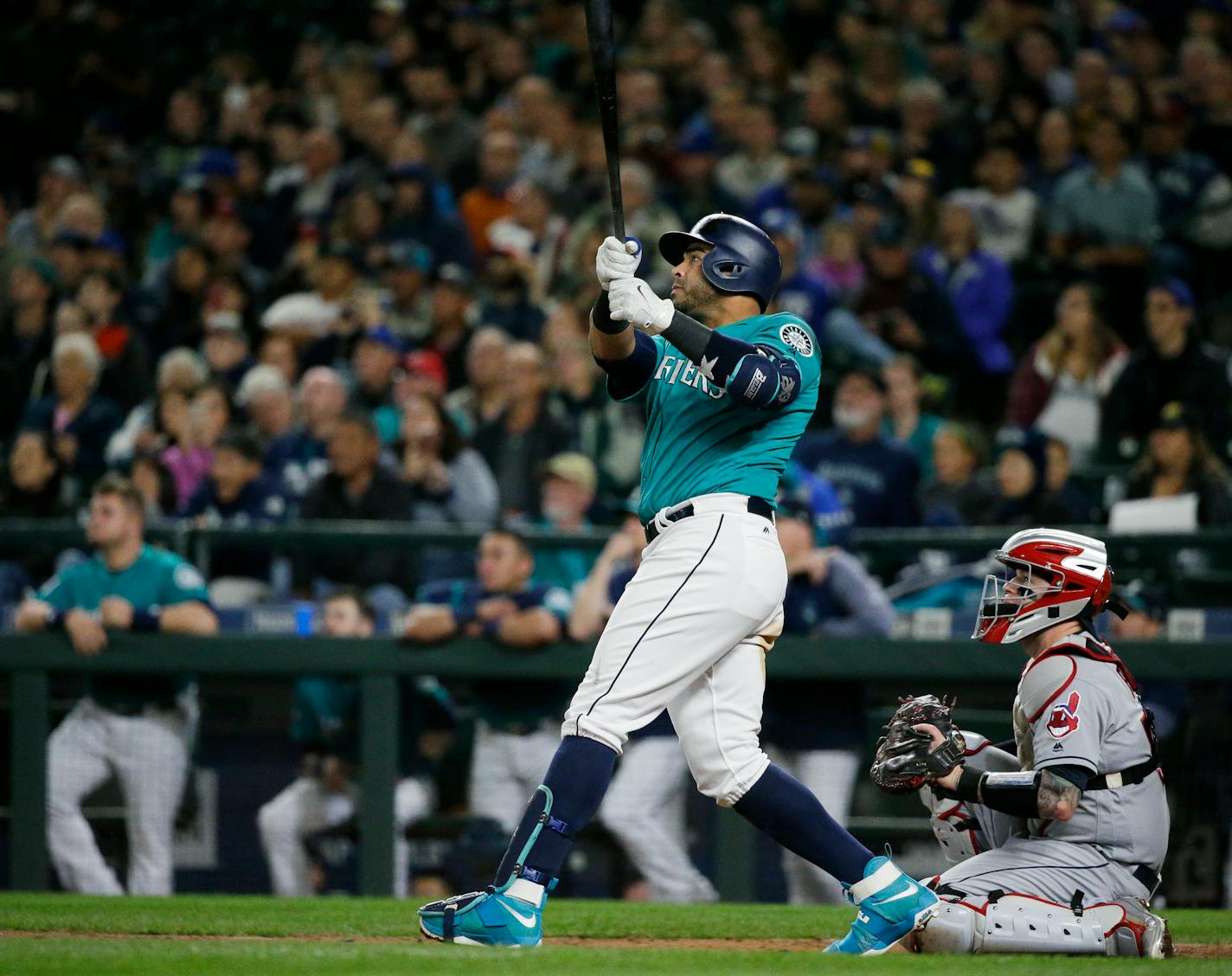 Seattle Mariners' Nelson Cruz watches his walk-off home run, which scored Robinson Cano, in the ninth inning of a baseball game against the Cleveland Indians, Friday, Sept. 22, 2017, in Seattle. The Mariners won 3-1. (AP Photo/Ted S. Warren)