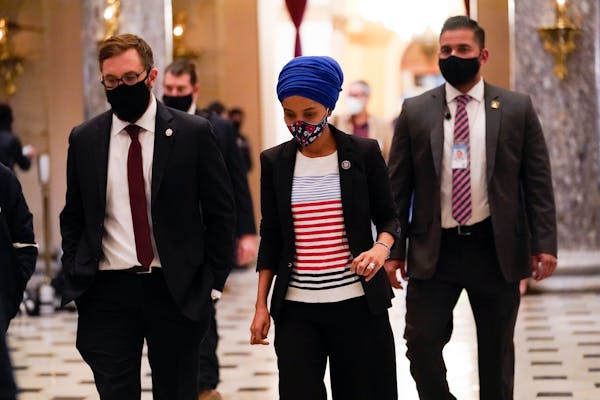 Rep. Ilhan Omar, D-Minn., walks to the House chamber on Capitol Hill in Washington, Wednesday, Jan. 13, 2021. 