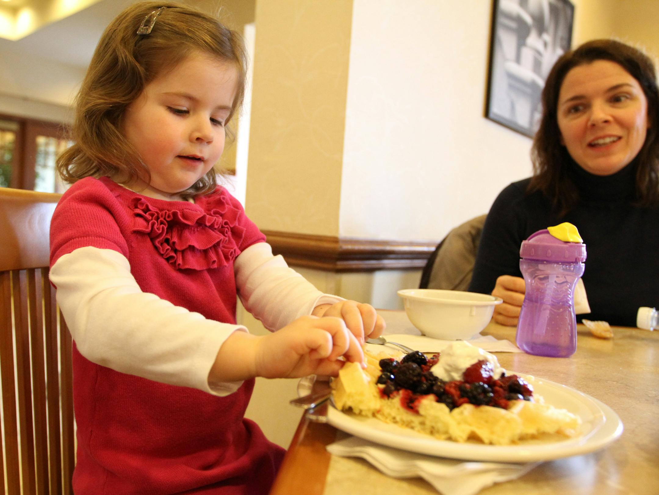 Hotel guests Elise McCollum (left, 3 years old, cq/source's mom) and her mother Marnee McCollum ate their complimentary breakfast with real plates, bowls and flateware (and fingers) on Wednesday morning. ] MARISA WOJCIK marisa.wojcik@startribune.com Wednesday, February 22, 2012 at the Country Inns and Suites by Carlson/Mall of America. The "Be Our Guest Breakfast" at the hotel has been revamped by no longer serving breakfast with disposable plates, cups and utensils. Real plates, cups and flatwa