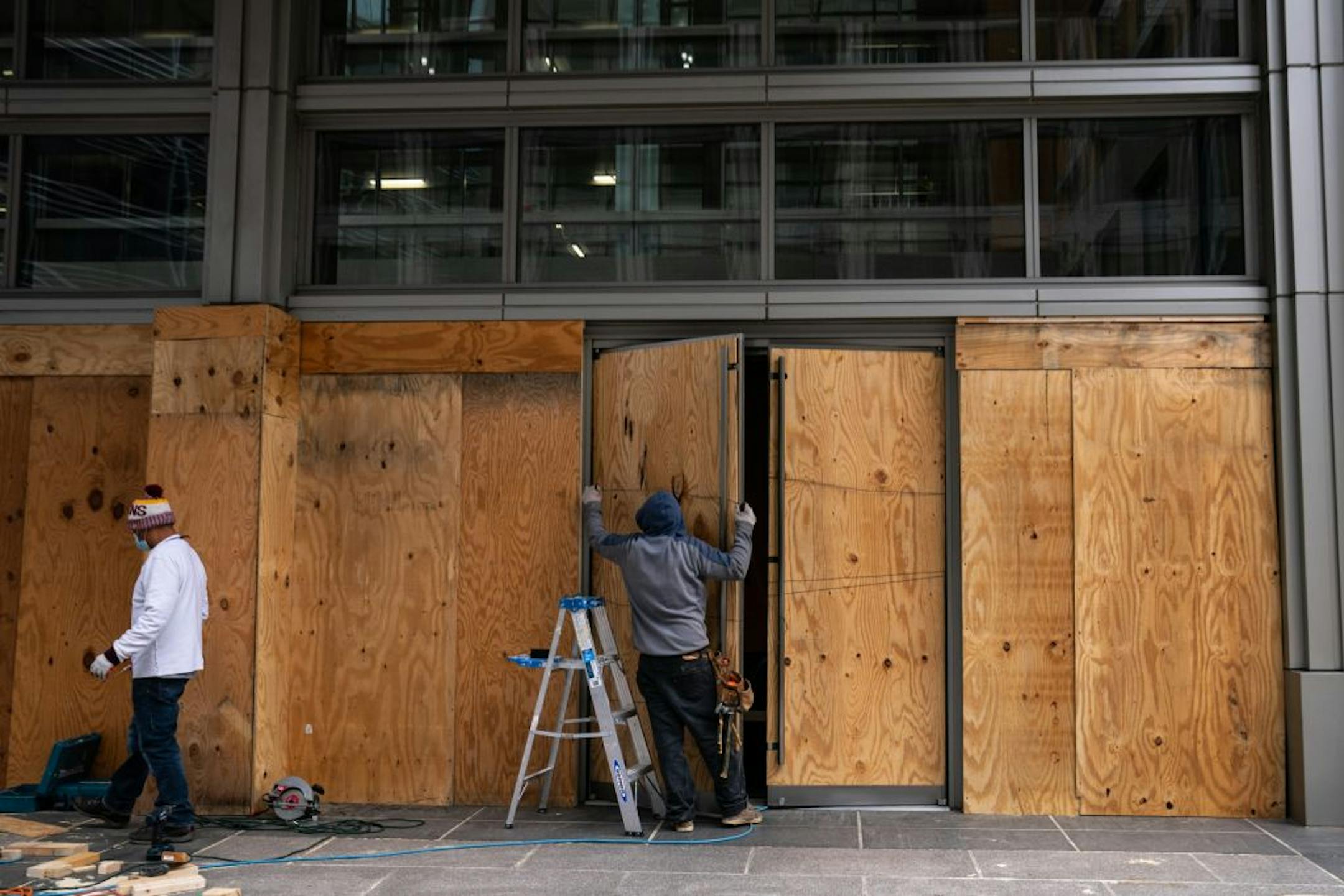 The windows of a storefront not far from the White House are boarded up in Washington, Oct. 30, 2020. As the nation races toward Election Day, disruptions in New Jersey, Texas, Georgia, North Carolina and elsewhere reflect a bitter, uncertain election.