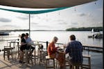 Patrons enjoy drinks, dinner and picture-perfect weather recently on the patio of Lola’s Lakehouse on Lake Waconia.