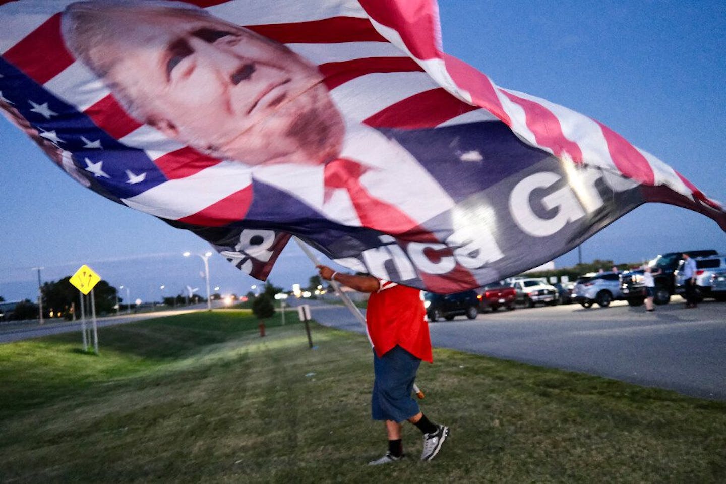 Randal Thom of Lakefield, Minn., walked to the highway to wave Trump flags with supporters during the August primary election.