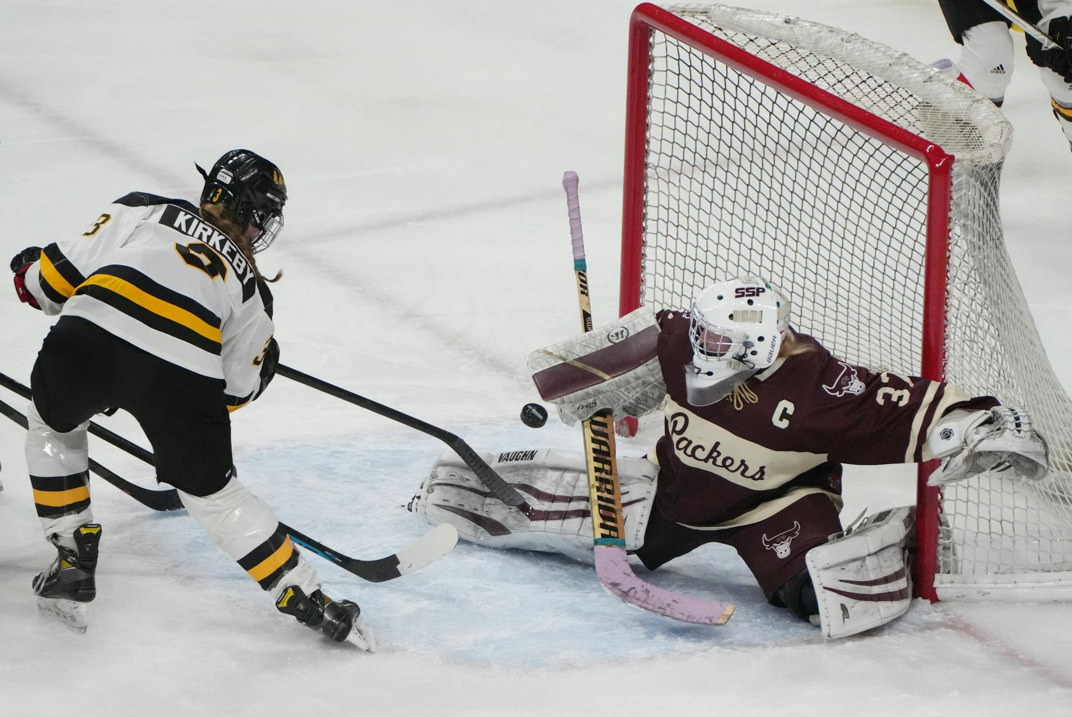 Warroad defenseman Lexi Kirkeby (3) lifts the puck above the pads of South St. Paul goaltender Delaney Norman (37) for a goal in the second period.