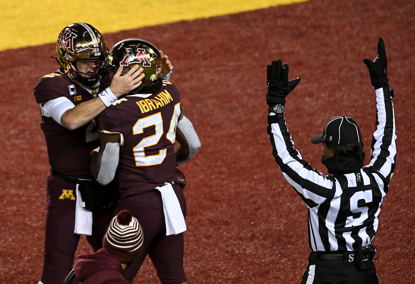 Minnesota Gophers quarterback Tanner Morgan (2) and running back Mohamed Ibrahim (24) celebrated a rushing touchdown by Ibrahim in the second quarter against the Michigan Wolverines.