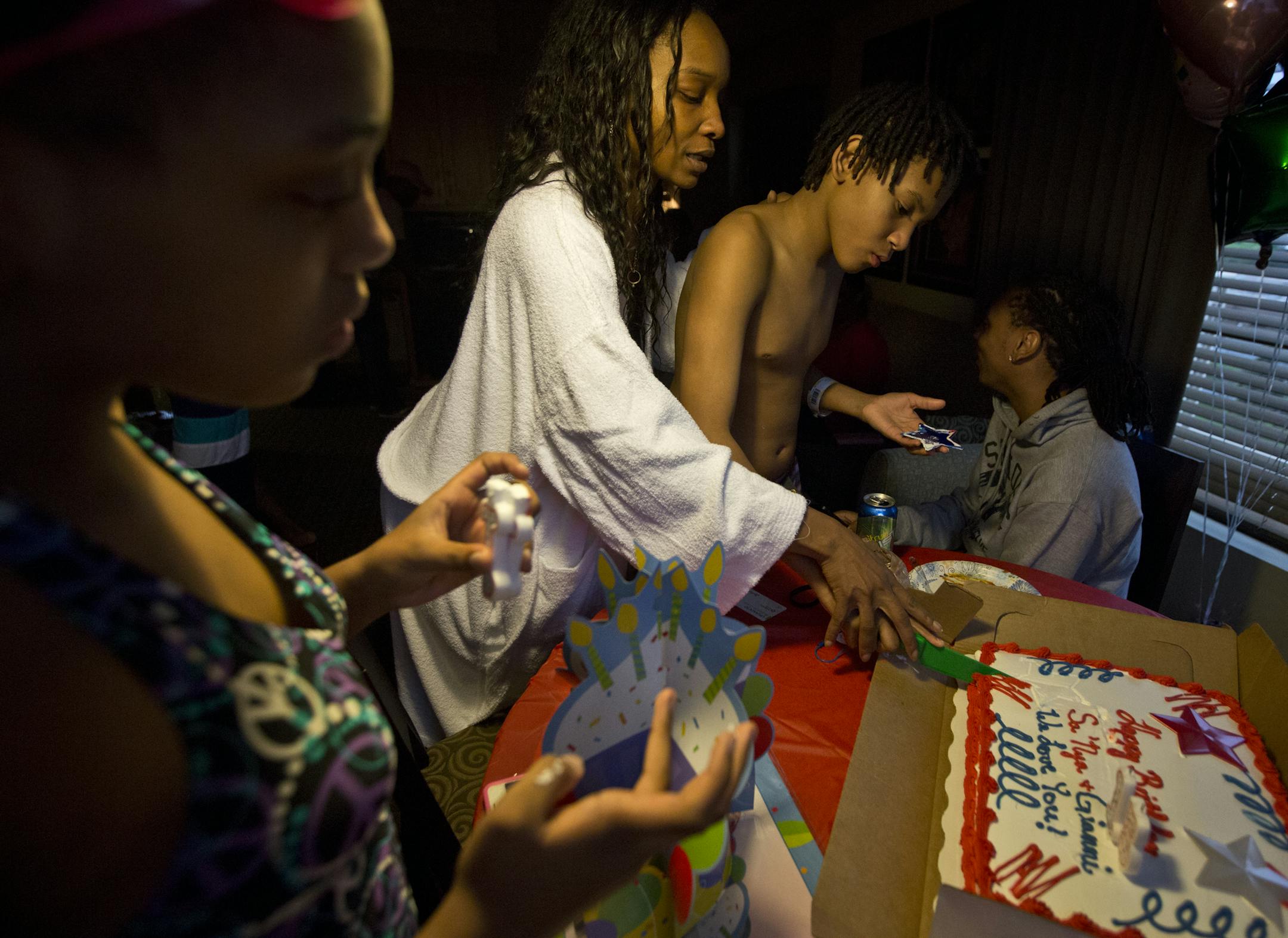 Shameka Griffin helped her son Gianni Griffin-Davis cut the cake during a make-up birthday party for Gianni (that he shared with his cousin) at the Waterpark of America in Bloomington, Minn., on Monday, May 27, 2013. Gianni turned 15 during his 37 day stint at the Ramsey County Juvenile Detention Center. ] (RENEE JONES SCHNEIDER * reneejones@startribune.com)