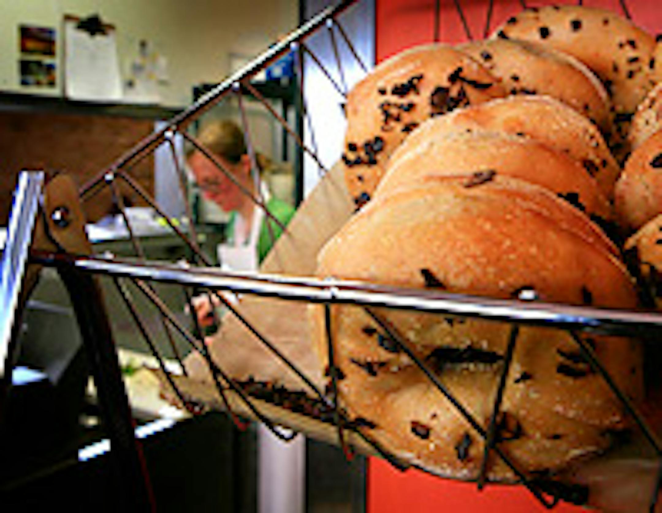 Onion bagels hang from a basket in Common Roots.
