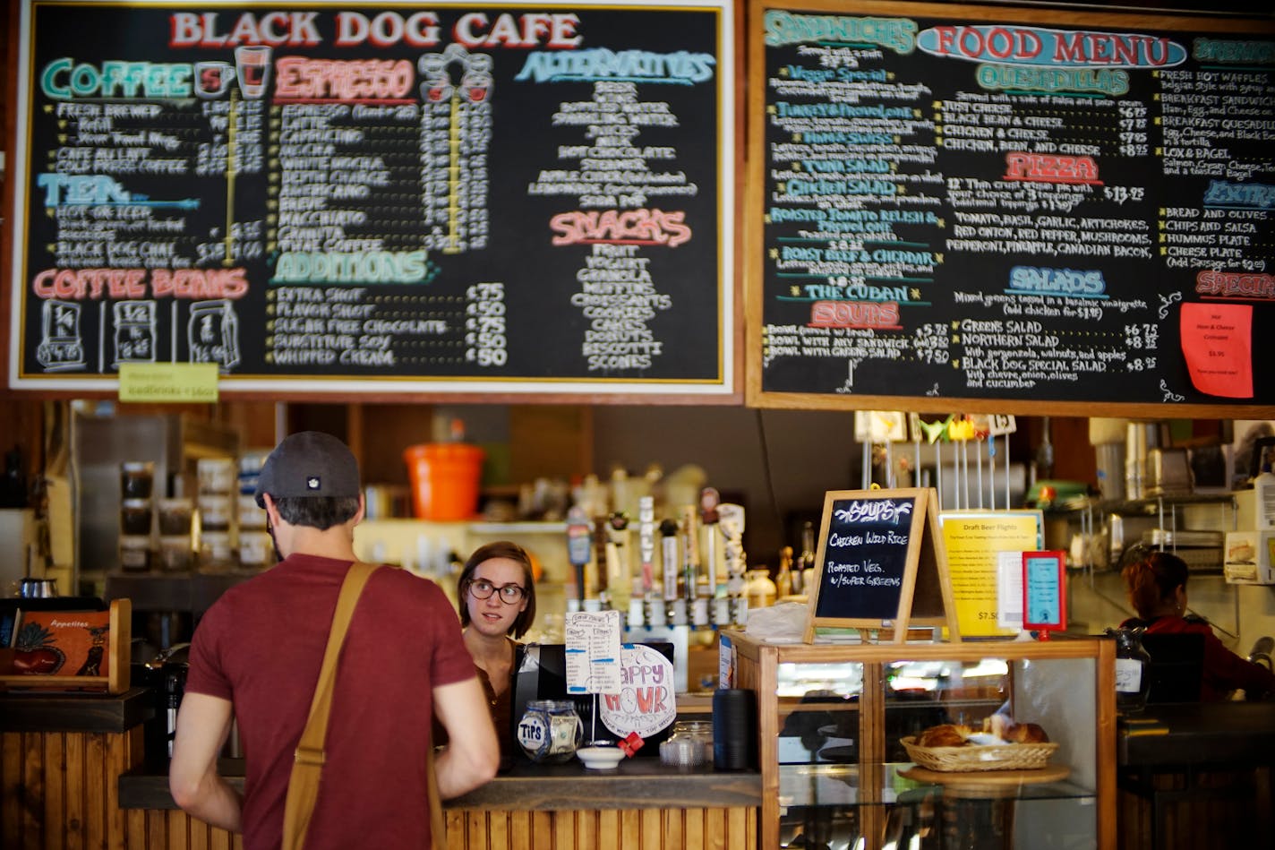 Lower town St. Paul has seen a revitalization that marks its as an increasingly popular oasis that celebrates art, music, good food. Barista Maria Koehne serves a customer at the Black Dog Cafe .] Richard Tsong-Taatarii/rtsong-taatarii@startribune.com