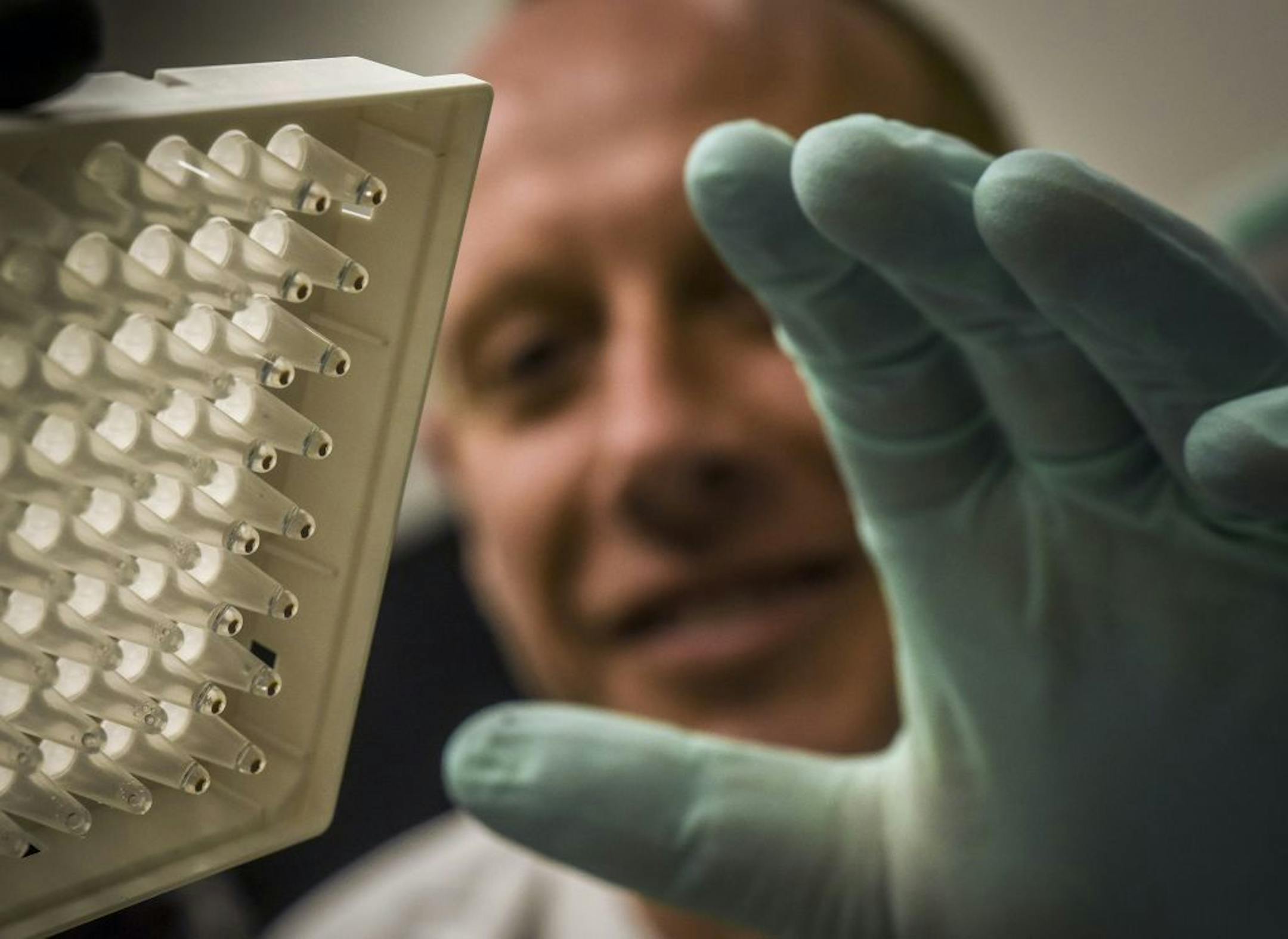 Patrick McGann checks a DNA sampling before loading it into a genome sequencer. Washington Post photo by Bill O'Leary.