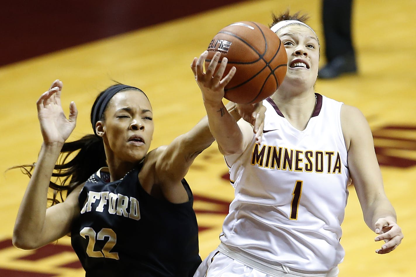 Rachel Banham attempted a shot between while being defended by Kentra Washington in the first quarter of the season opener.