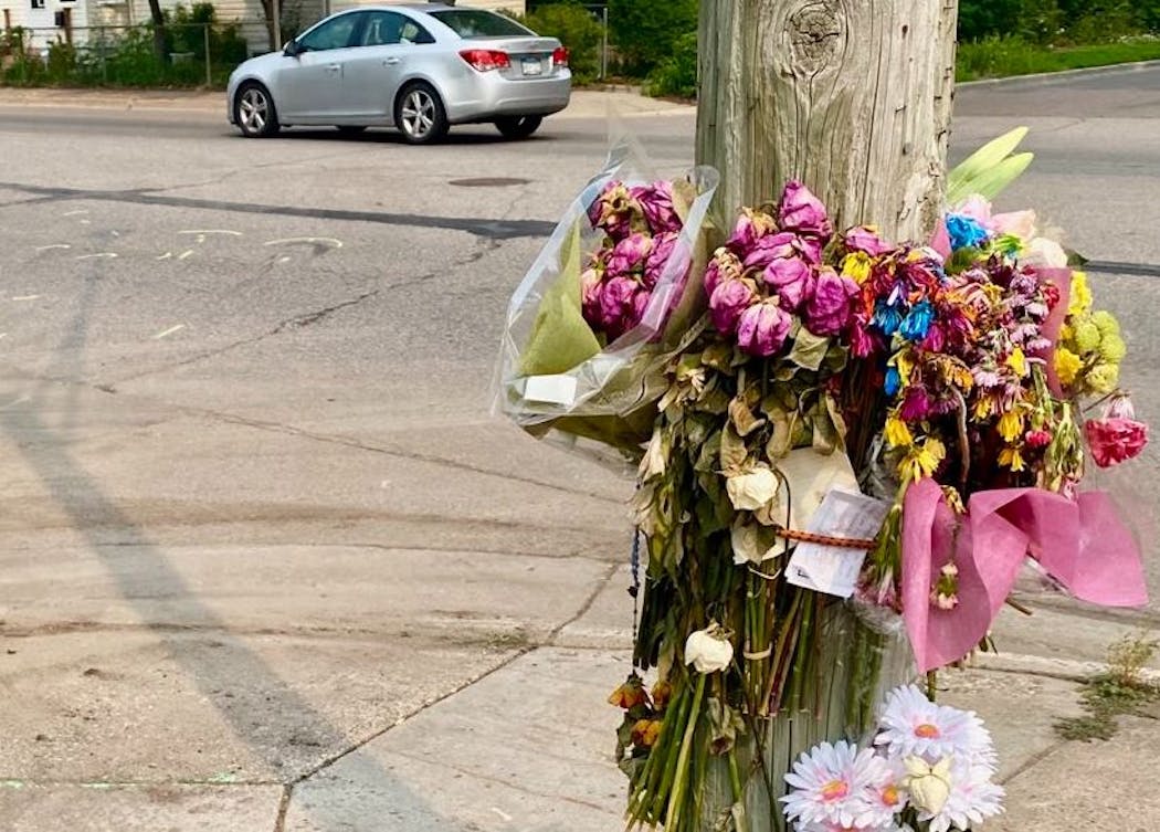 A floral memorial and traffic investigation markings on the pavement are reminders of when  Emily Gerding lost her life in a crash on July 8 in Robbinsdale.