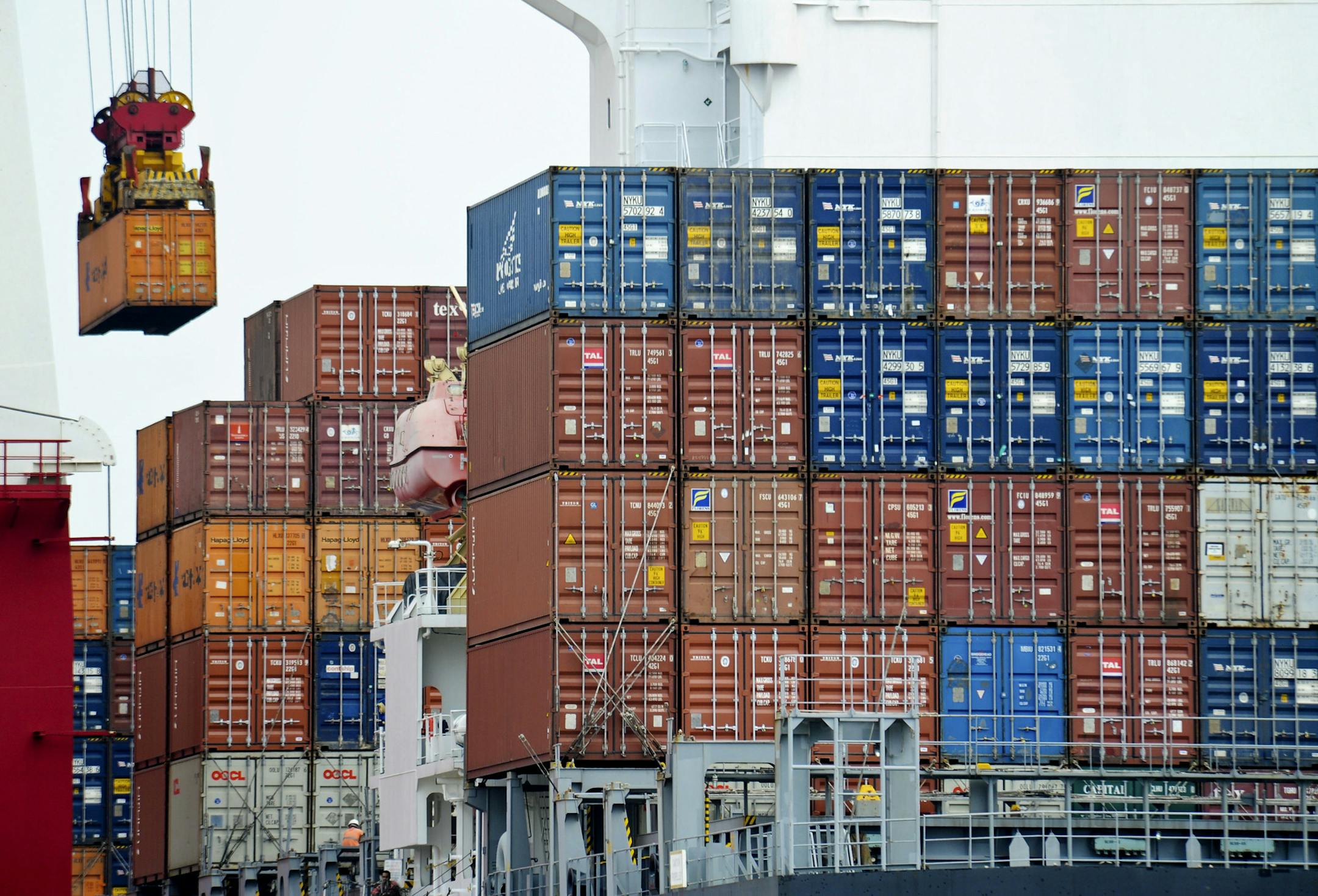 FILE- In this file photo taken on Aug. 5, 2010, a container is loaded onto a cargo ship at the Tianjin port in China. China's exports fell again in October in a fresh sign of weak global demand that is complicating efforts by Beijing leaders to shore up economic growth and reduce reliance on trade and investment. (AP Photo/Andy Wong, File)