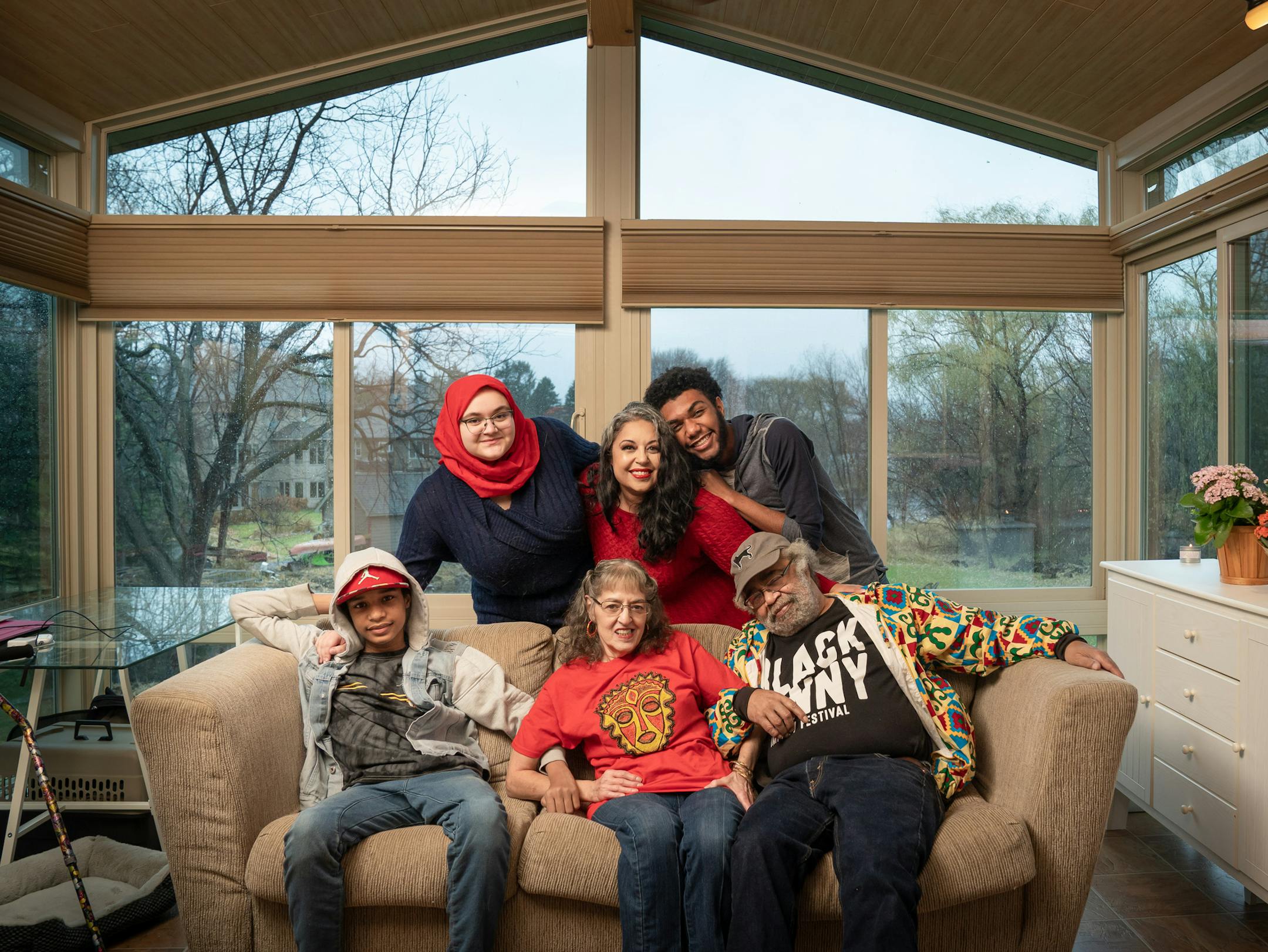 Erin Horne McKinney, center, standing brought her parents Roni and Alexander McKinney, her sons Malachi, 13 and Solomon,18, and her niece Aliya, 17, to live together in her New Brighton home. They moved here two weeks ago and are still unpacking boxes. ] GLEN STUBBE • glen.stubbe@startribune.com Monday, November 9, 2020 People who have decided to make the Twin Cities their part-time home during the pandemic. EDS, Malachi is on the left, Solomon on the right, hugging his mom Erin, Both sons have