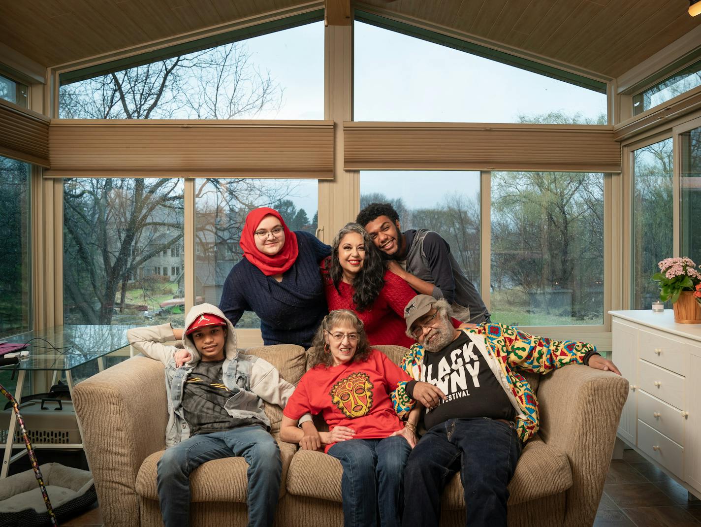 Erin Horne McKinney, center, standing brought her parents Roni and Alexander McKinney, her sons Malachi, 13 and Solomon,18, and her niece Aliya, 17, to live together in her New Brighton home. They moved here two weeks ago and are still unpacking boxes. ] GLEN STUBBE • glen.stubbe@startribune.com Monday, November 9, 2020 People who have decided to make the Twin Cities their part-time home during the pandemic. EDS, Malachi is on the left, Solomon on the right, hugging his mom Erin, Both sons have