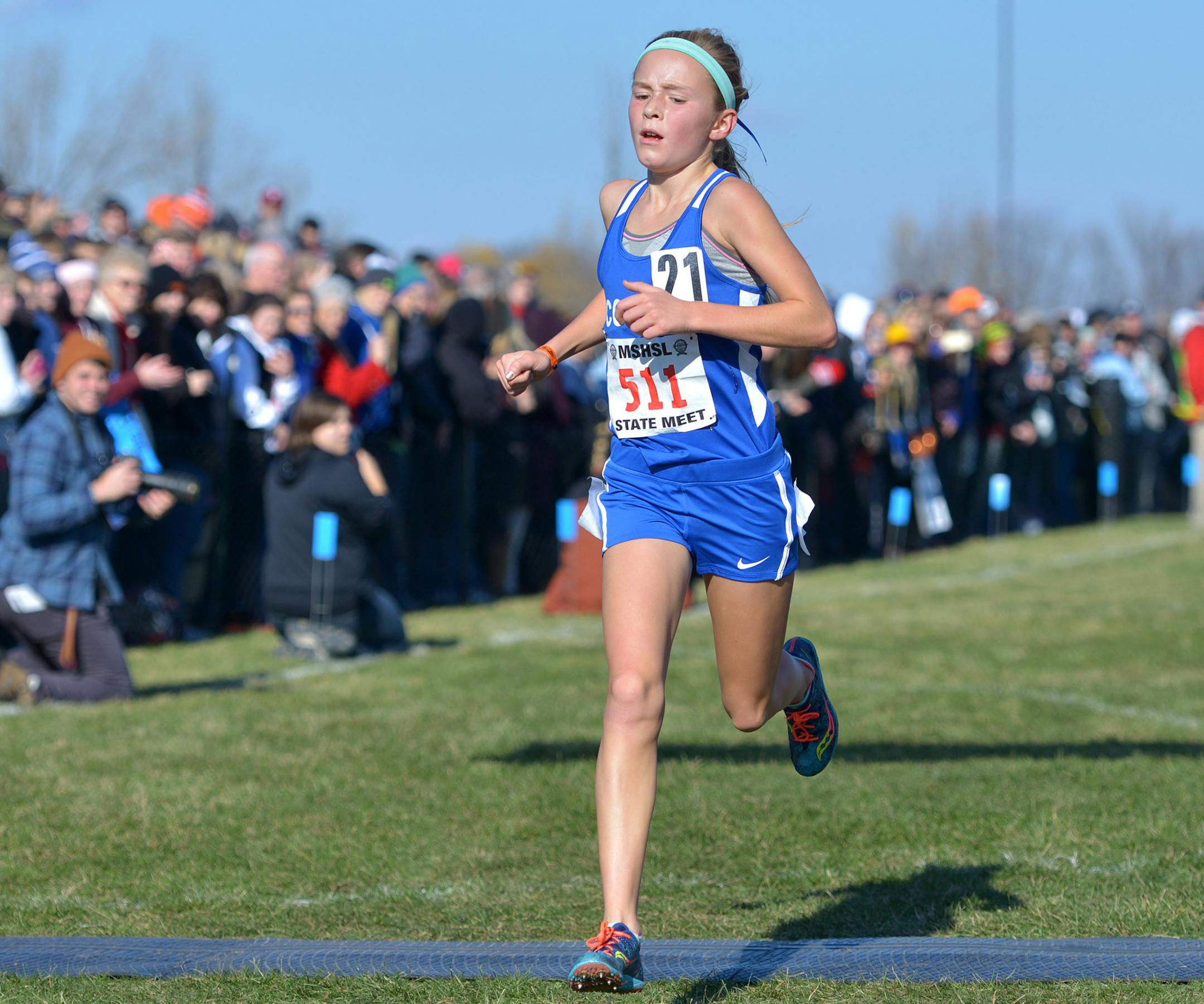 Cotter seventh-grade Grace Ping leads the race by nearly a minute as she nears the finish line of the girls' Class 1A state cross country championship race Saturday, November 7 at St. Olaf College in Northfield. Ping's time of 17:52.0 claimed a new state record. ] (SPECIAL TO THE STAR TRIBUNE/BRE McGEE) **Grace Ping (Cotter, seventh grade)