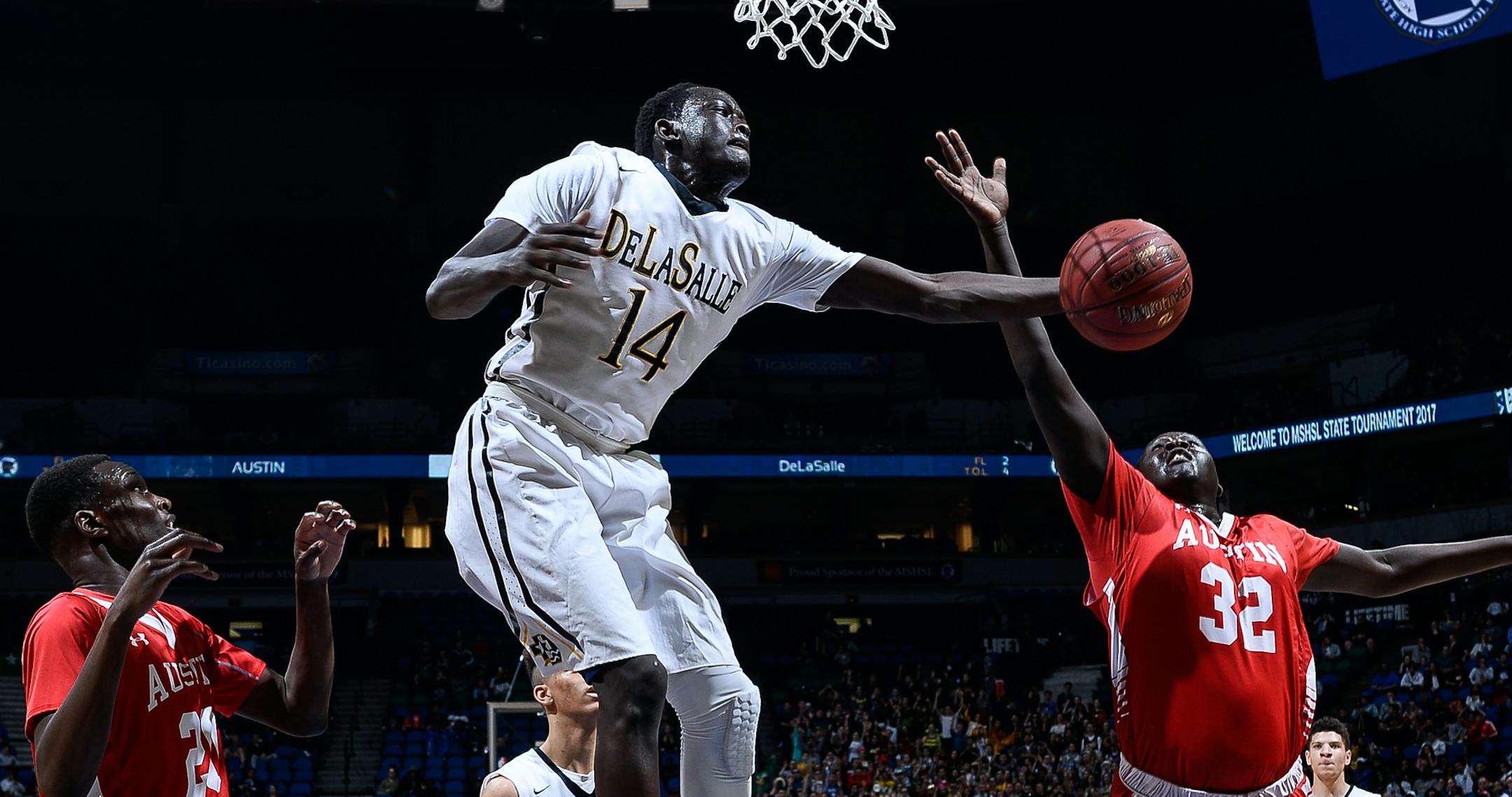 DeLaSalle forward Goanar Mar (14) pulled down an offensive rebound in the first half while being surrounded by Austin defenders, including forward Oman Oman (32) and guard Duoth Gach (23). ] AARON LAVINSKY ï aaron.lavinsky@startribune.com Austin played DeLaSalle in the Class 3A State Tournament Championship Game on Saturday, March 25, 2017 at Target Center in Minneapolis, Minn.