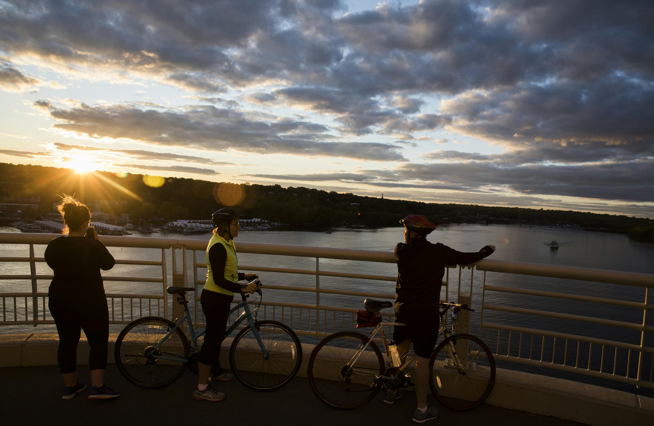 Gina Goetzke, from left, of Cottage Grove, stops with her parents Claire and Jerry Goetzke of Stillwater, in the middle of the new St. Croix bridge for a sunset photo. ] LEILA NAVIDI ï leila.navidi@startribune.com BACKGROUND INFORMATION: The pedestrian walkway on the new St. Croix bridge in St. Croix County, Wis. on Friday, September 29, 2017.