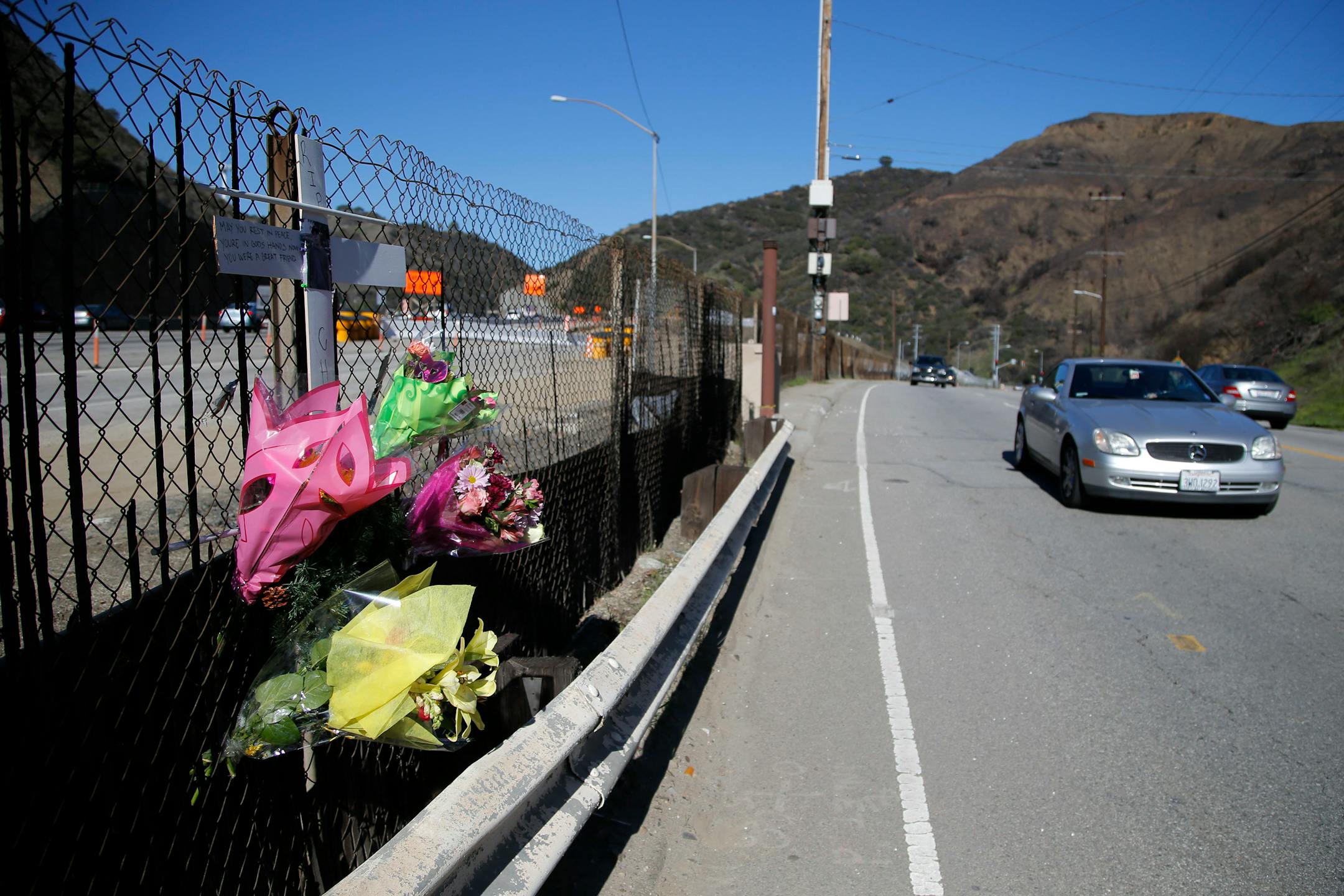 A roadside memorial for a paparazzo, who was killed by a car while darting across a street after taking pictures of Justin Bieber's Ferrari, is seen near the 405 Freeway in Los Angeles, Wednesday, Jan. 2, 2013. A paparazzo was struck and killed by a car while darting across a street after taking pictures of Justin Bieber's Ferrari when it was pulled over along a freeway in Los Angeles, police said Wednesday. (AP Photo/Jae C. Hong)