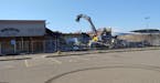 Crews started tearing down Midway Shopping Center in St. Paul on Tuesday.