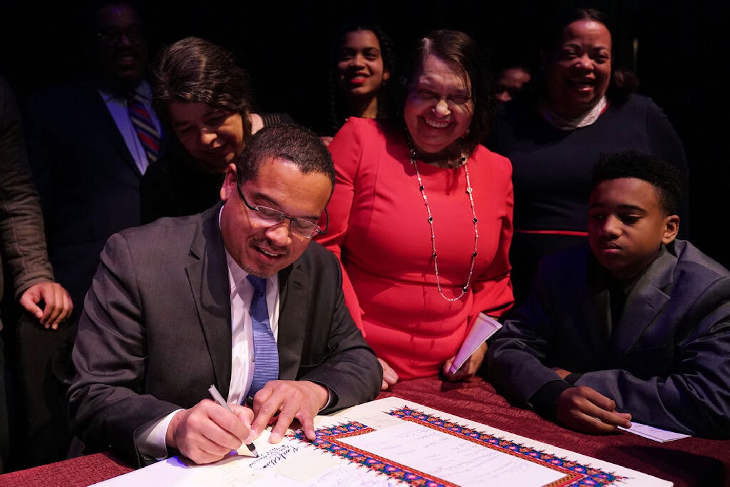 Attorney General Keith Ellison signed the paperwork to make it official after he took the oath of office as his mother, Clida, stood next to him at the Fitzgerald Theater in St. Paul, Minn. ] ANTHONY SOUFFLE • anthony.souffle@startribune.com