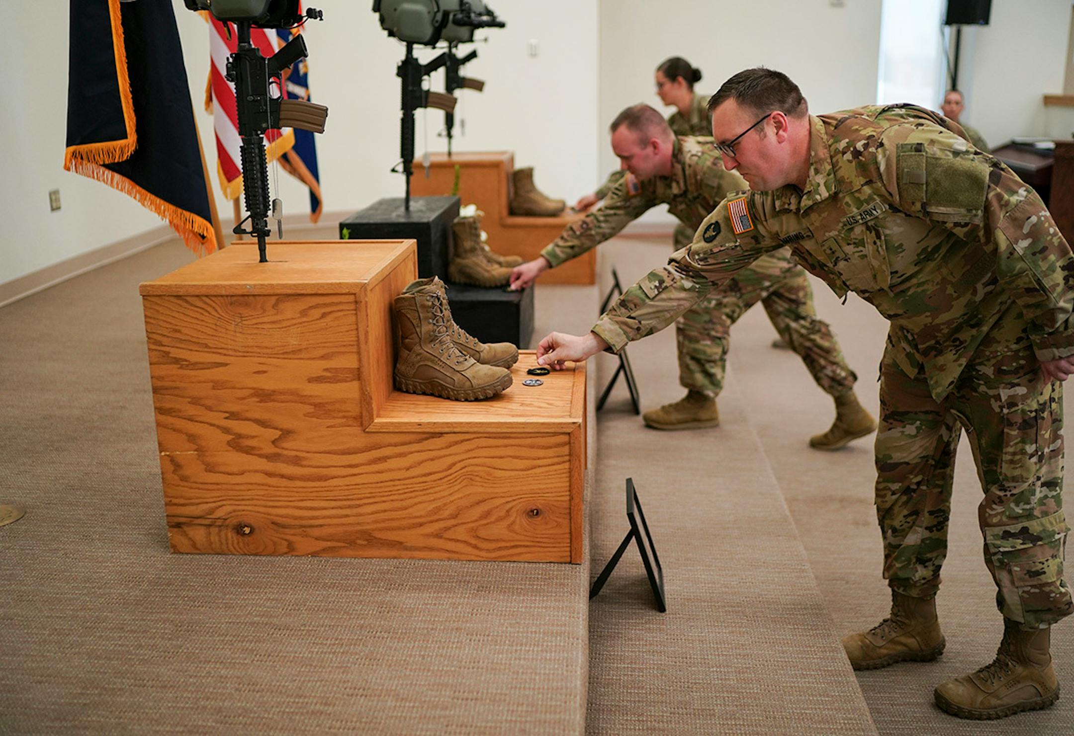 Chief Warrant Officer Michael Kahring gave his unit patch to the memorial for his friend Chief Warrant Officer James A. Rogers Jr., during a memorial ceremony in North Fort Hood.