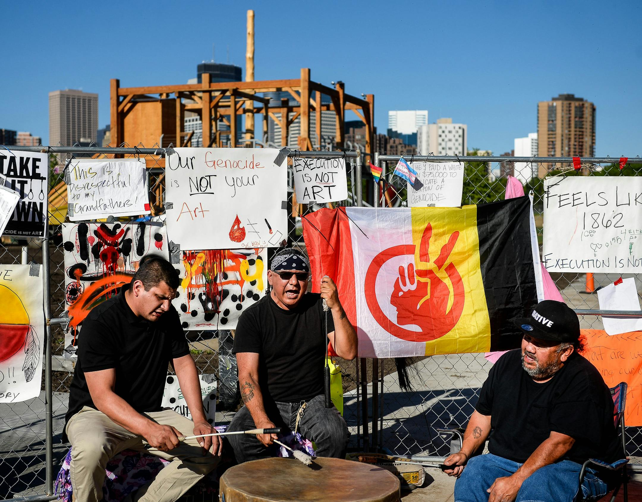 Members of the Dakota Sioux tribe held a drum ceremony in front of the "Scaffold" sculpture by Sam Durant Wednesday outside the Minneapolis Sculpture Garden. "Maybe (the spirits of) our ancestors who were hung will come if they hear this drum," said Virgil Blacklance, with the Lower Sioux, the middle drummer. To his side were Freddie LoneEagle, left, of Red Lake, and Aaron Rock, from White Earth. ] AARON LAVINSKY • aaron.lavinsky@startribune.com A group of Dakota tribal elders met Wednesd