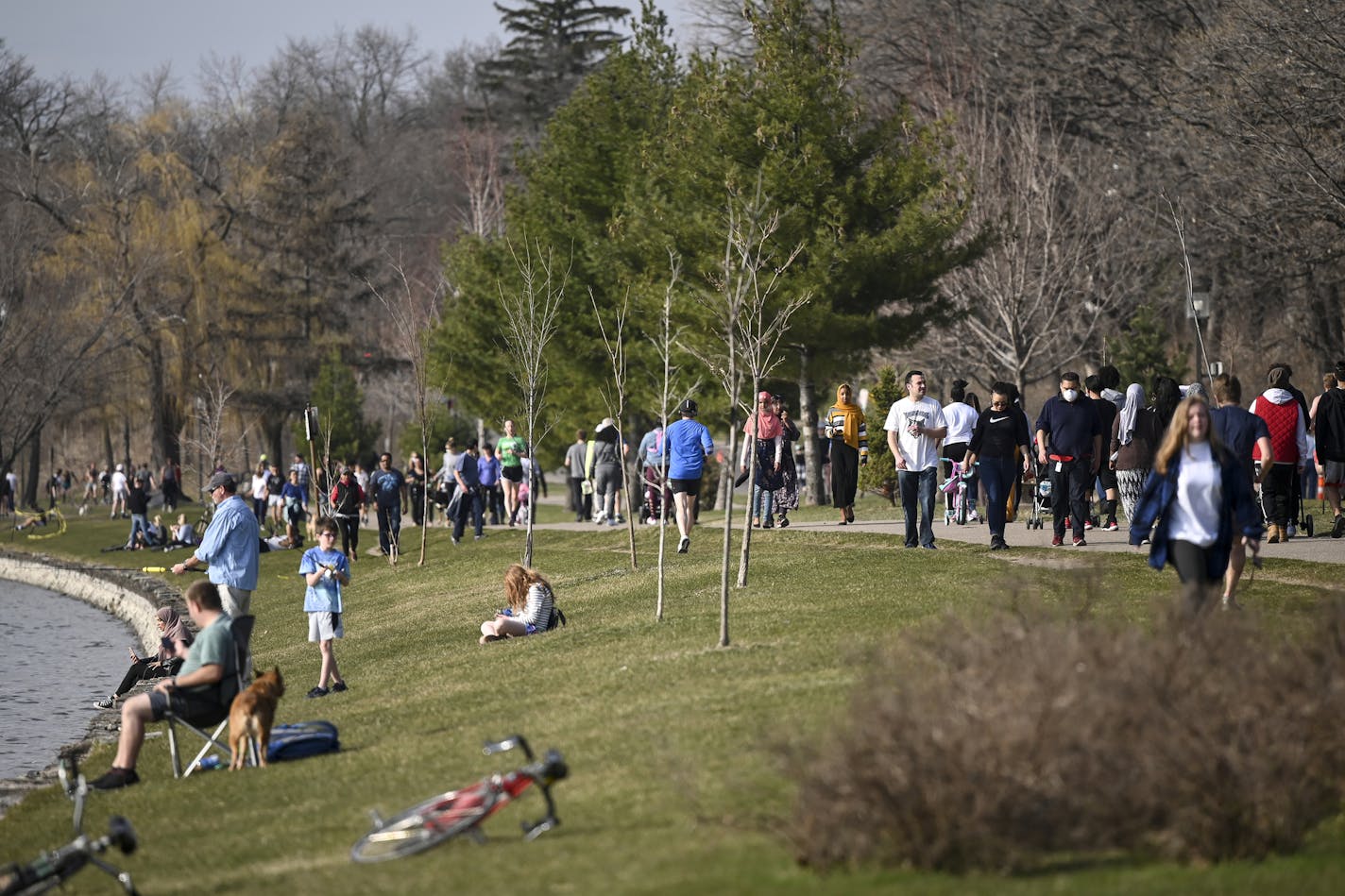 Hundreds of pedestrians and cyclists spent the afternoon at Bde Maka Ska Wednesday. ] aaron.lavinsky@startribune.com Minneapolis' parks have become a source of respite for anyone needing peace of mind during Gov. Walz's stay-at-home order to control the coronavirus outbreak. Enter the Minneapolis Park Board and Superintendent Al Bangoura. We take an inside look at how the board is making decisions to open or close parkways, how they're monitoring social distancing and why they're so keen on keep