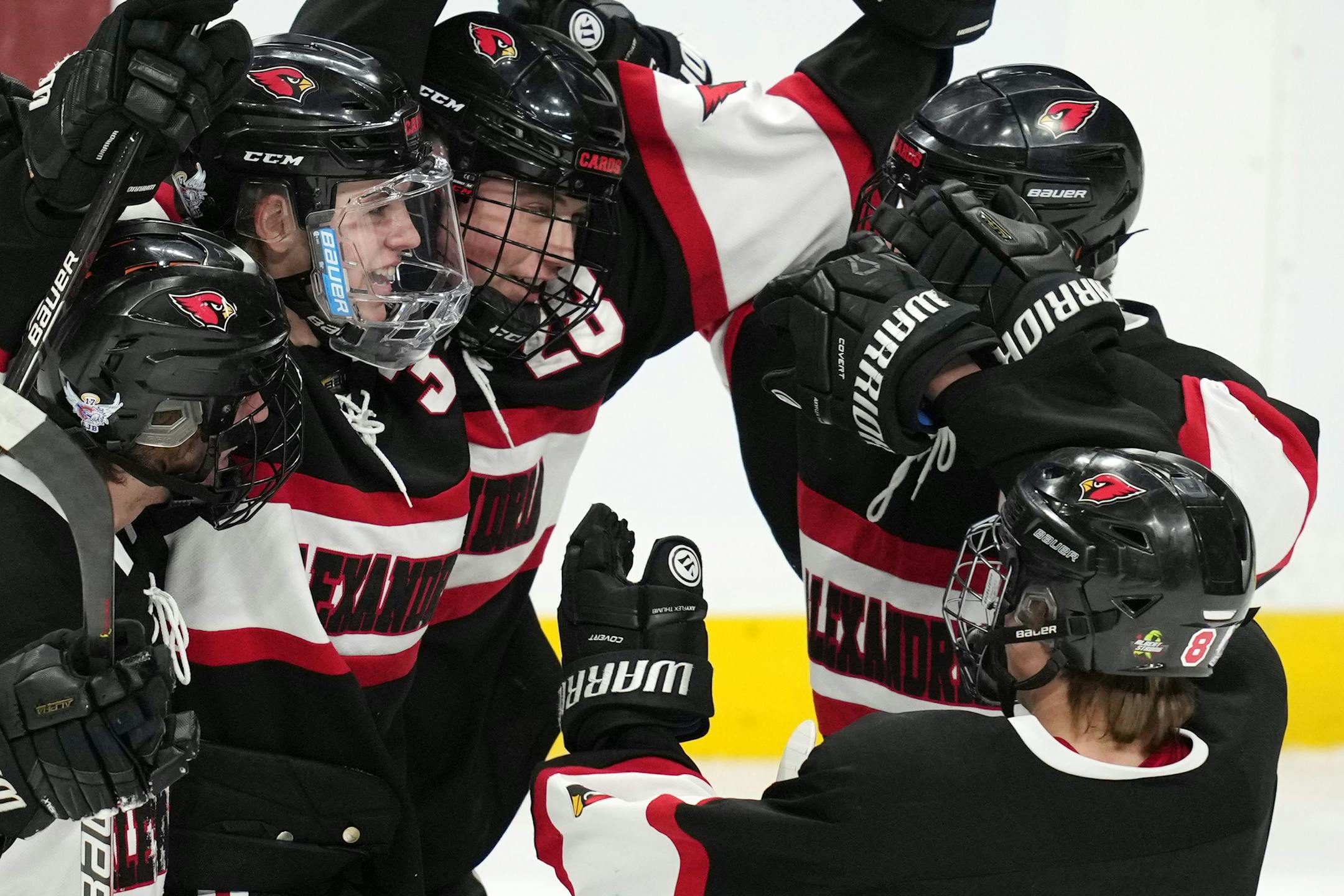 Alexandria forward Leonard Kompelien (3) celebrates with his teammates after scoring in the first period of a MSHSL Class 1A quarterfinal hockey game between Alexandria and Mahtomedi.
