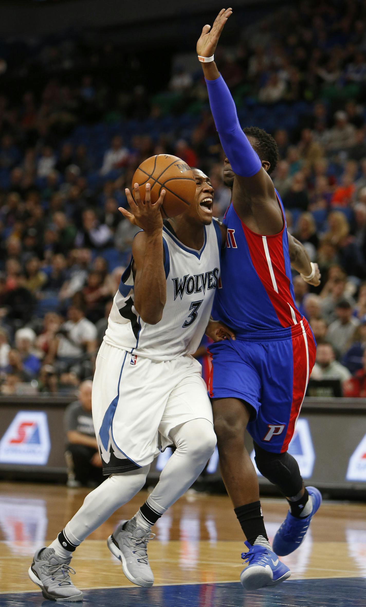 Minnesota Timberwolves guard Kris Dunn (3) tries to pass the ball around Detroit Pistons guard Reggie Jackson in the first half of an NBA basketball game Friday, Dec. 9, 2016, in Minneapolis. (AP Photo/Stacy Bengs)