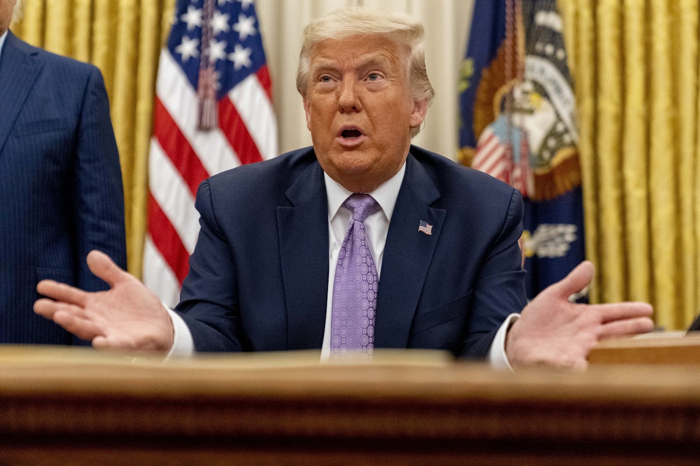 President Donald Trump speaks in the Oval Office at the White House, Wednesday, Aug. 12, 2020, in Washington.