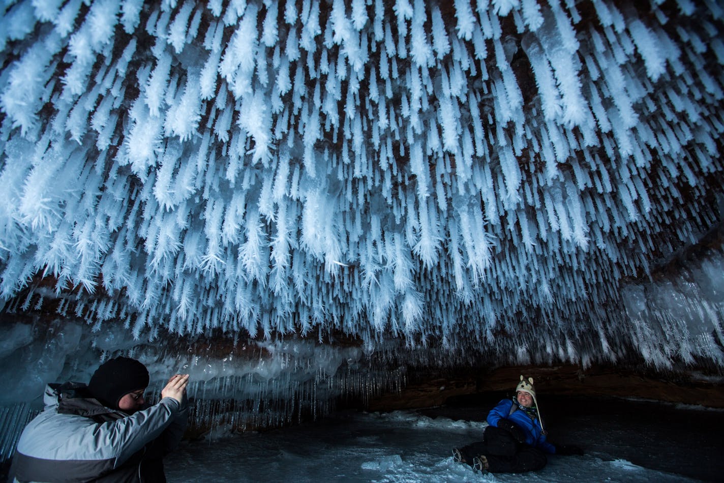 James Kuhn, left, of Seattle, and Edward Mitchell, of Detroit, explore an ice cave at the Apostle Islands National Lakeshore on Lake Superior, Friday, Feb. 27, 2015, near Bayfield, Wis.