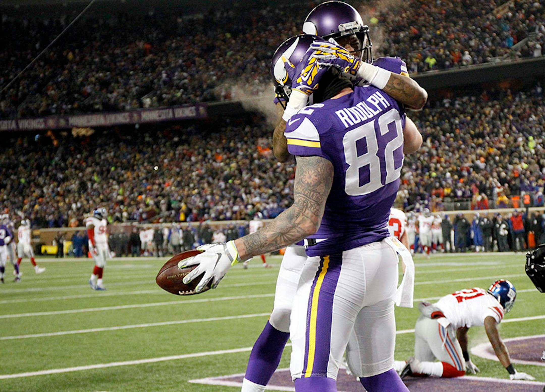 Minnesota Vikings wide receiver Mike Wallace (11) hugs Minnesota Vikings tight end Kyle Rudolph (82) after Rudolph's touchdown during the first half of an NFL football game against the New York Giants, Sunday, Dec. 27, 2015, in Minneapolis.