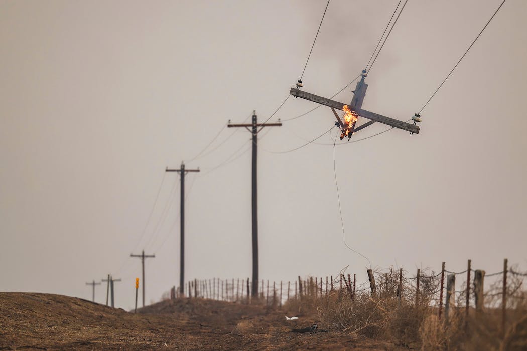 A telephone pole burns from the Smokehouse Creek Fire on Feb. 28 in Canadian, Texas. 