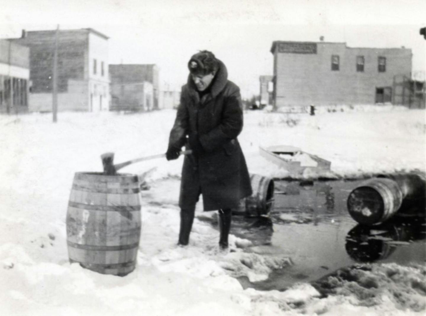 The border town of Ranier, Minn., was a bootlegging center during Prohibition. A police officer smashed a barrel during the Great Whiskey Raid of 1932.