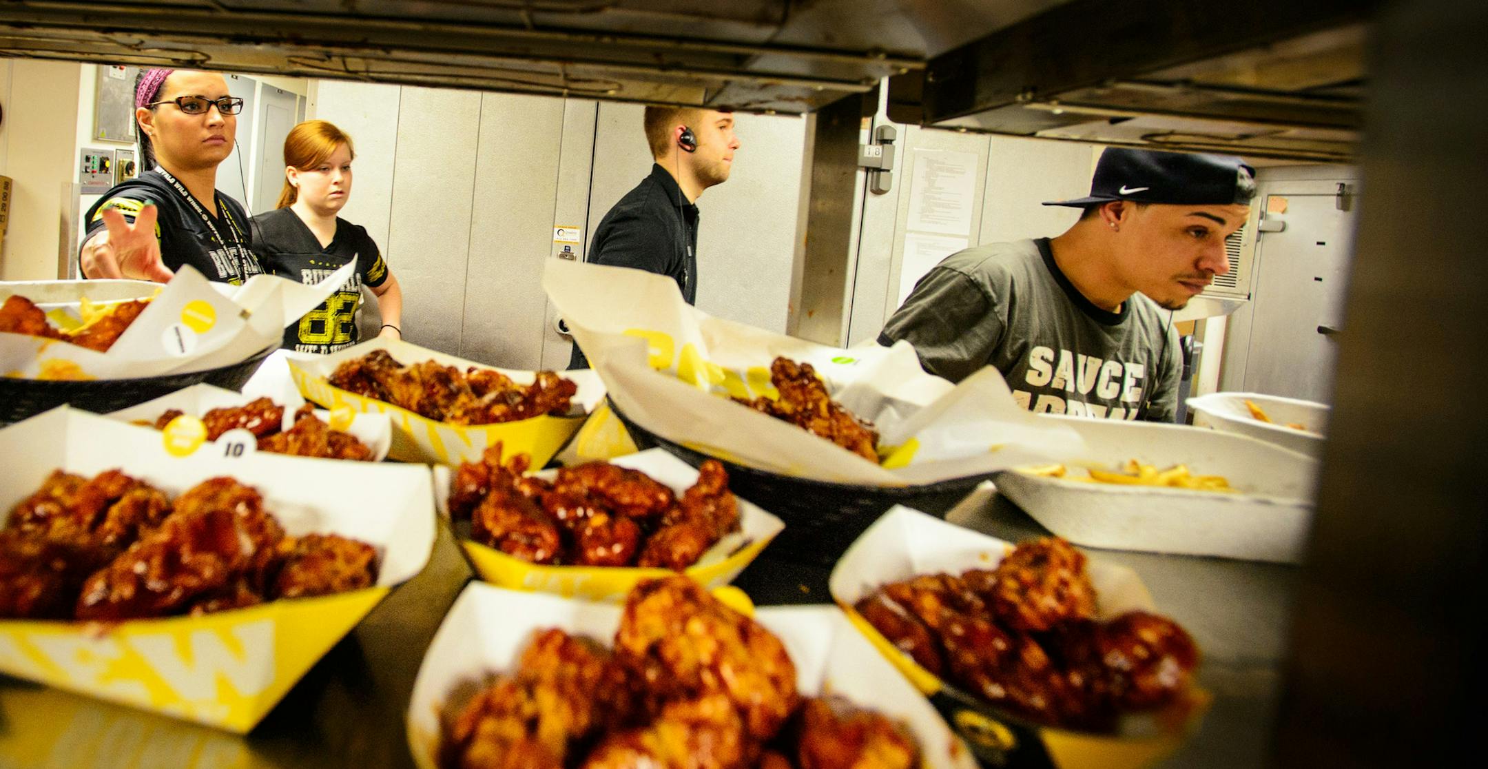 The kitchen crew kept meals flowing to customers during a busy lunchtime at the start of the NCAA tournament. Buffalo Wild Wings at the University of Minnesota ] GLEN STUBBE * gstubbe@startribune.com Thursday, March 20, 2014.